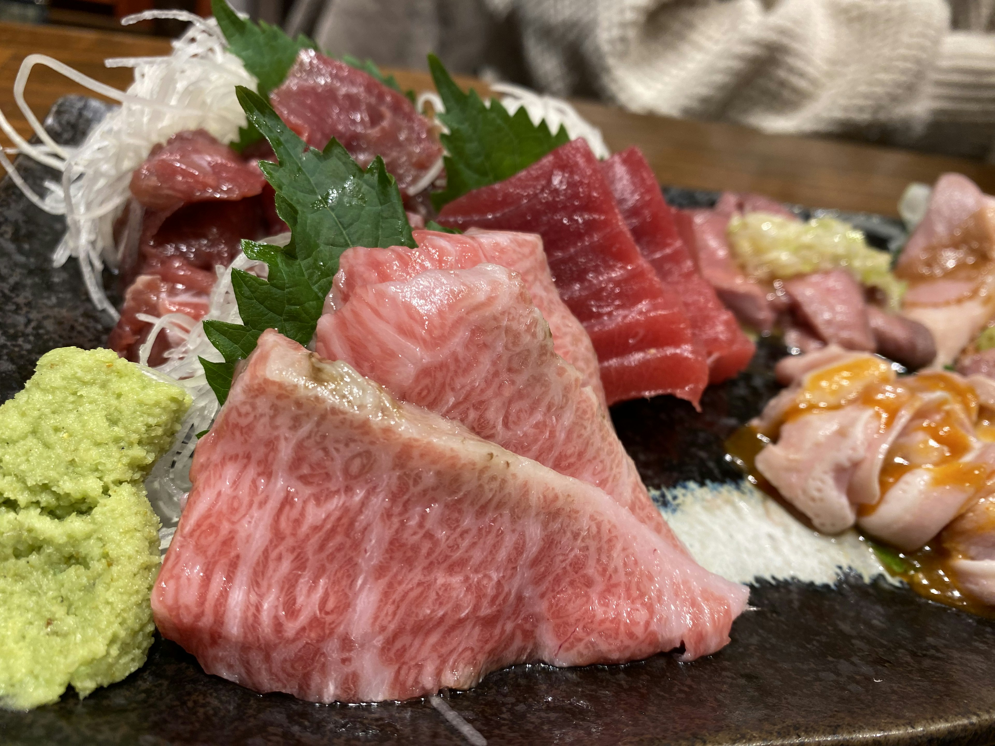 Platter of fresh sashimi with wasabi and garnishes