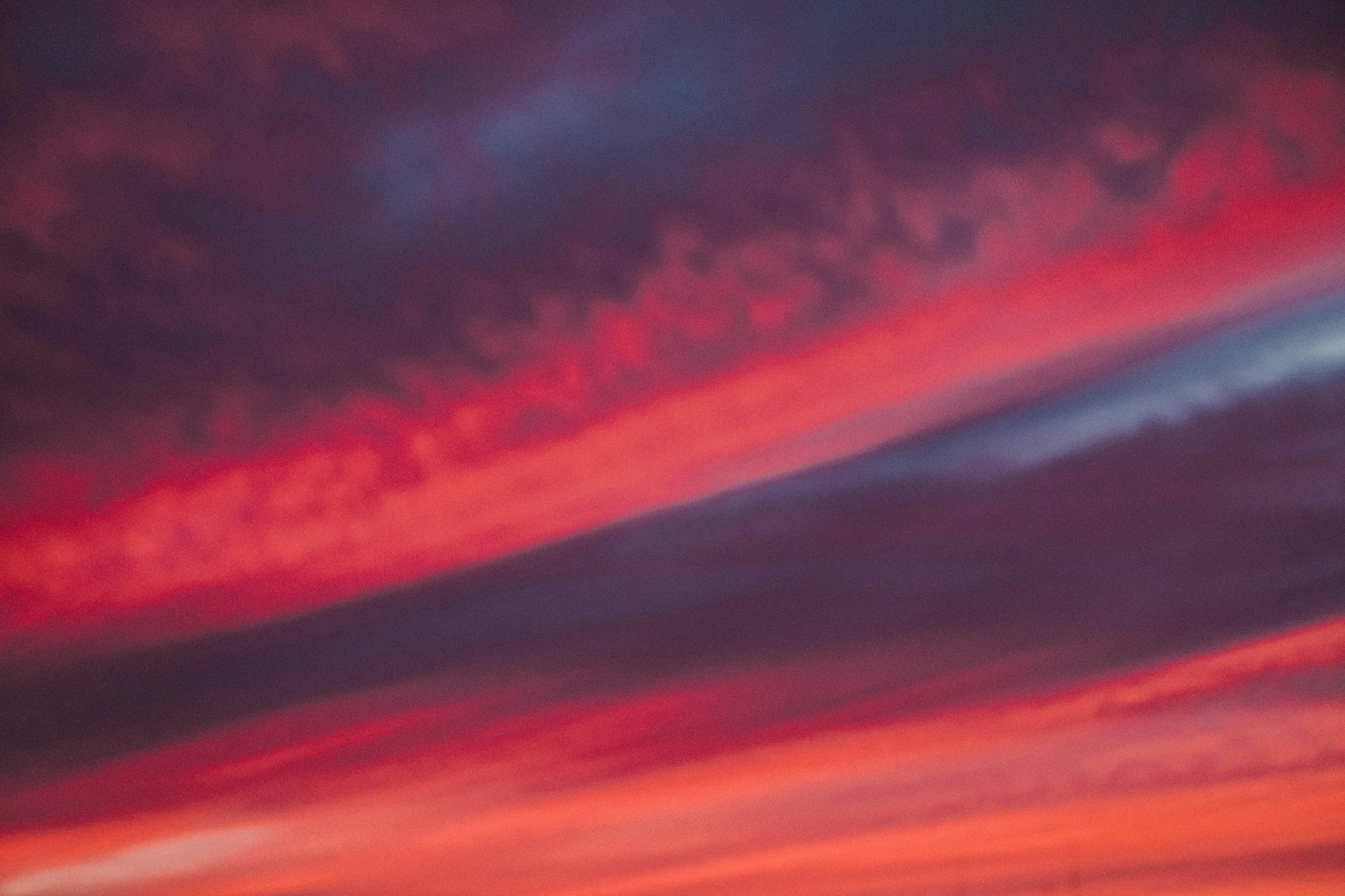 Franjas de nubes rojas y azules en un cielo de atardecer