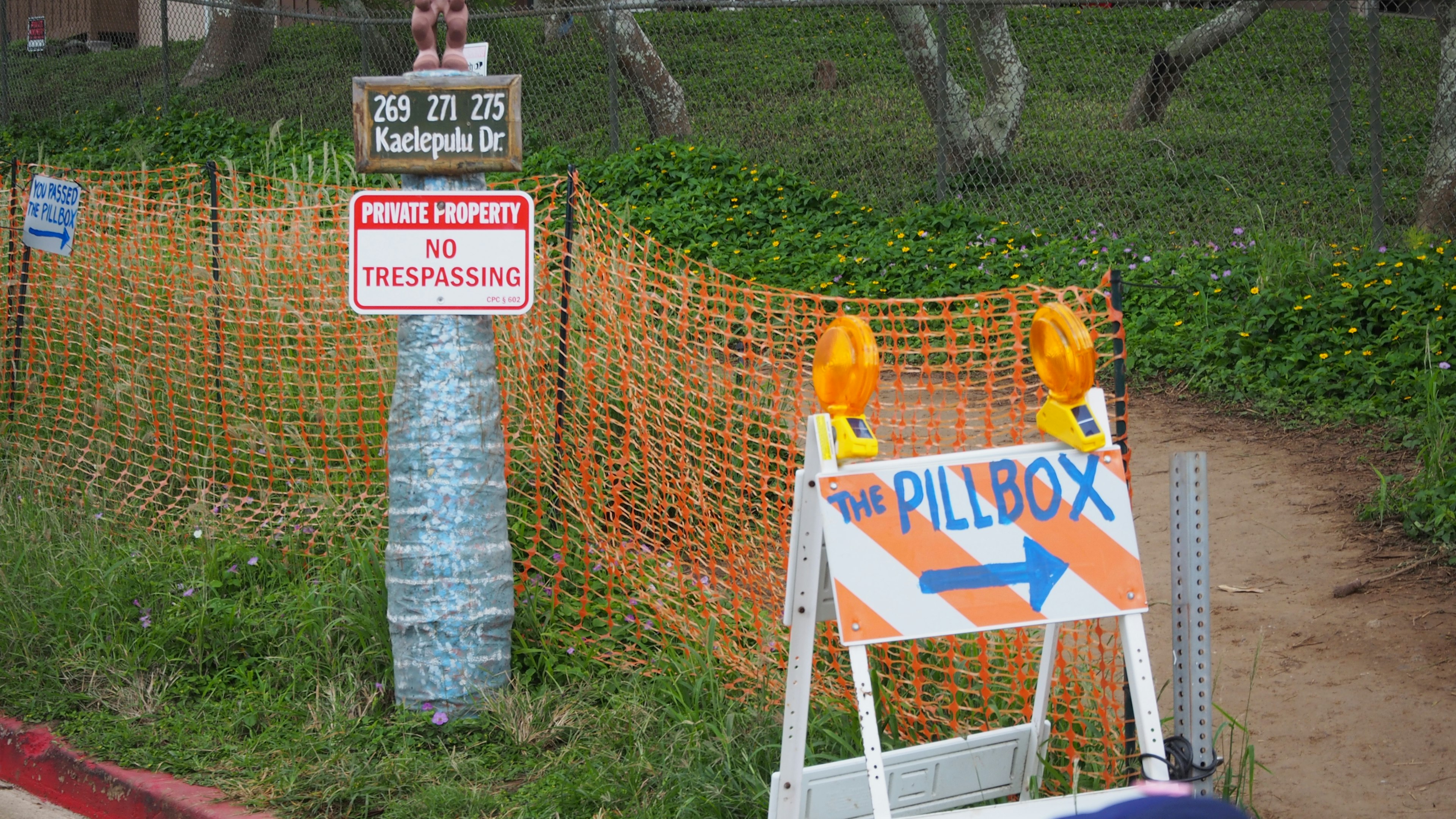 Construction site with warning signs and orange safety fence