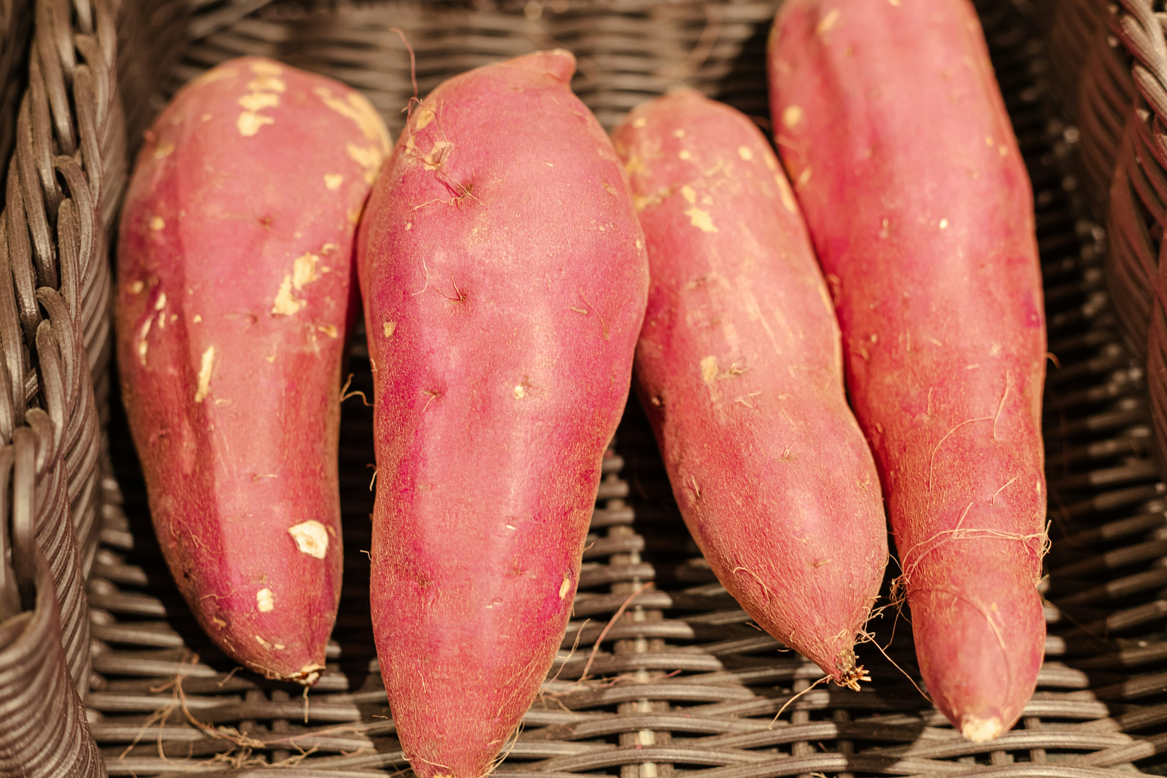 A set of sweet potatoes in a basket