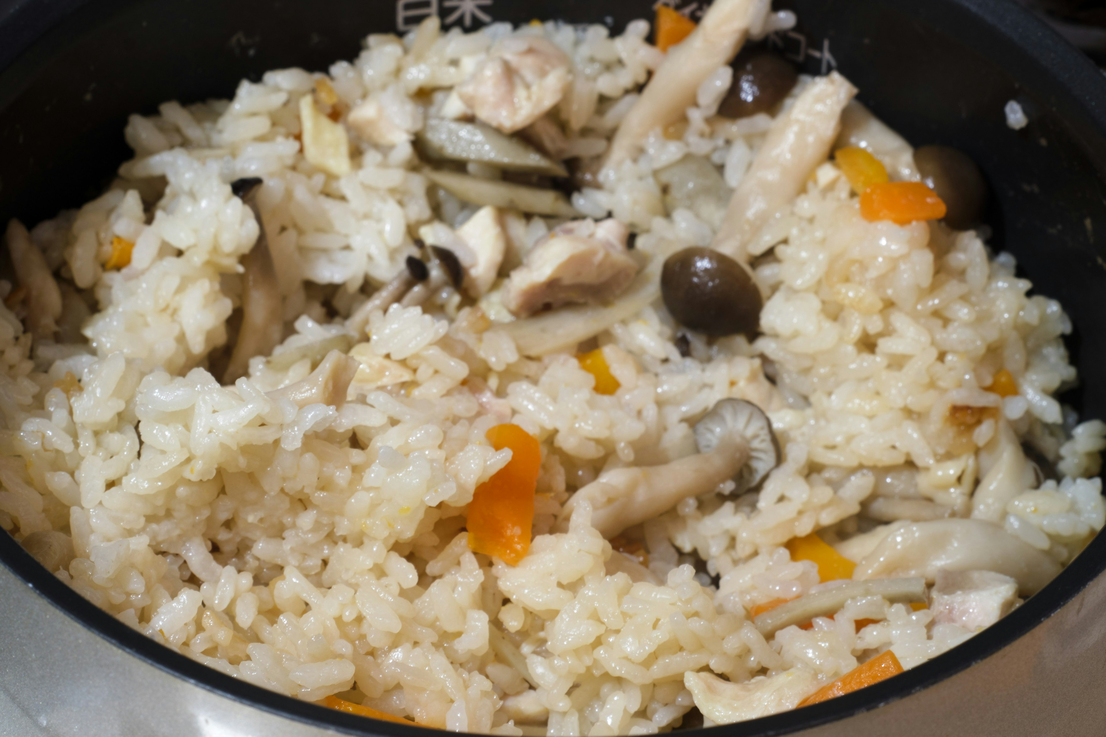 Creamy risotto with chicken and mushrooms in a pot