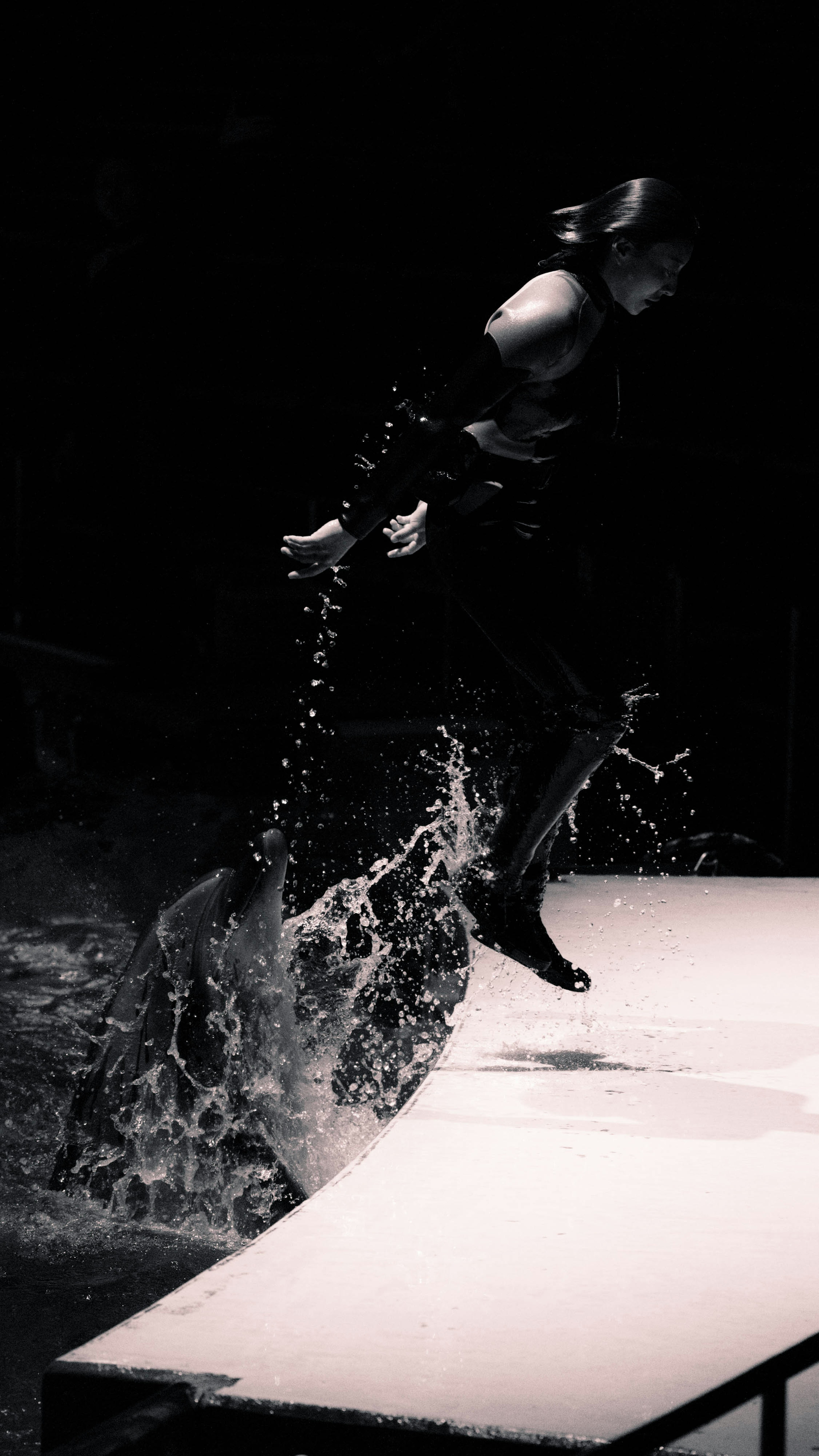 Silhouette of a performer jumping and splashing water