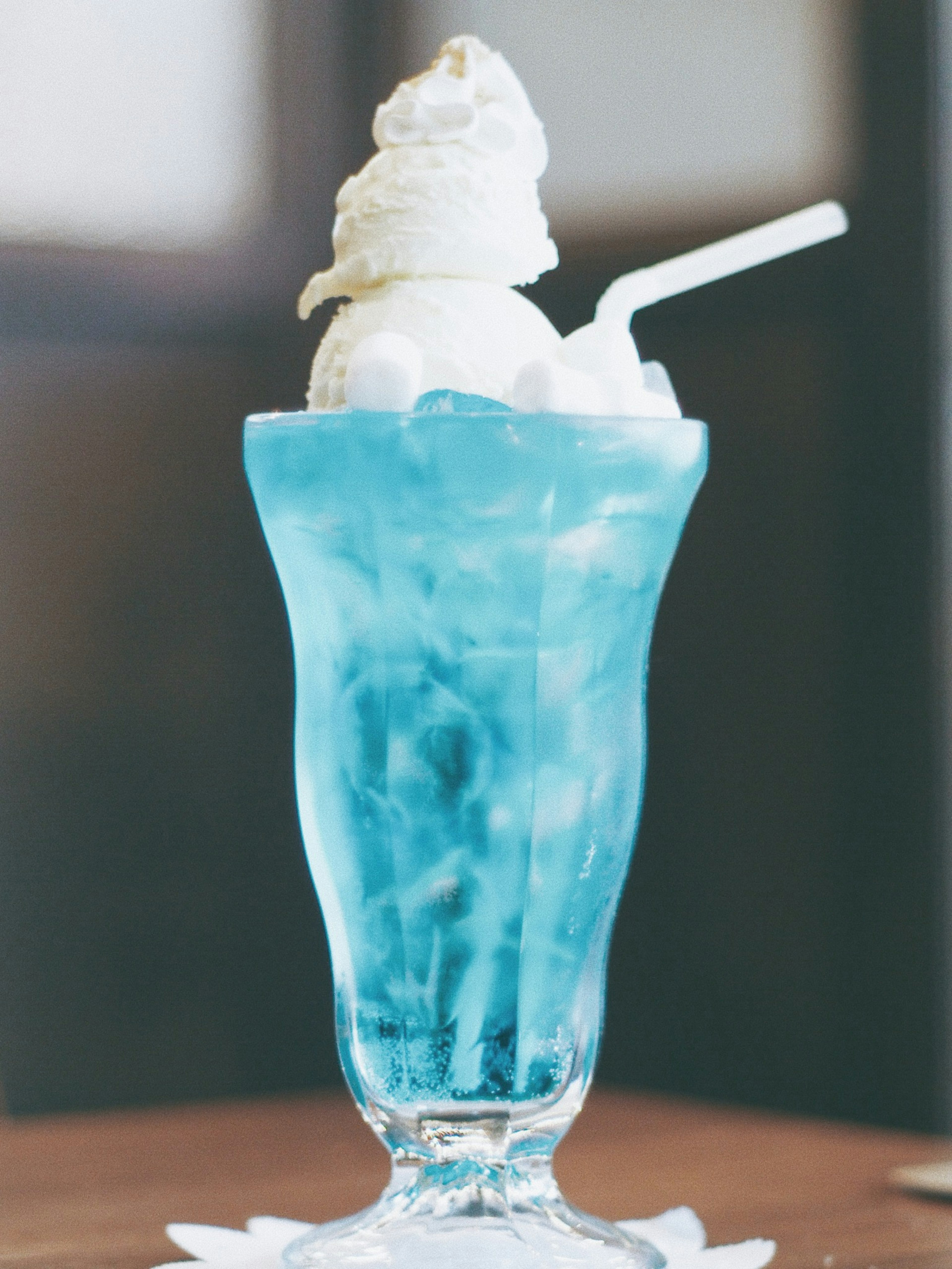 Blue beverage with ice cream dessert