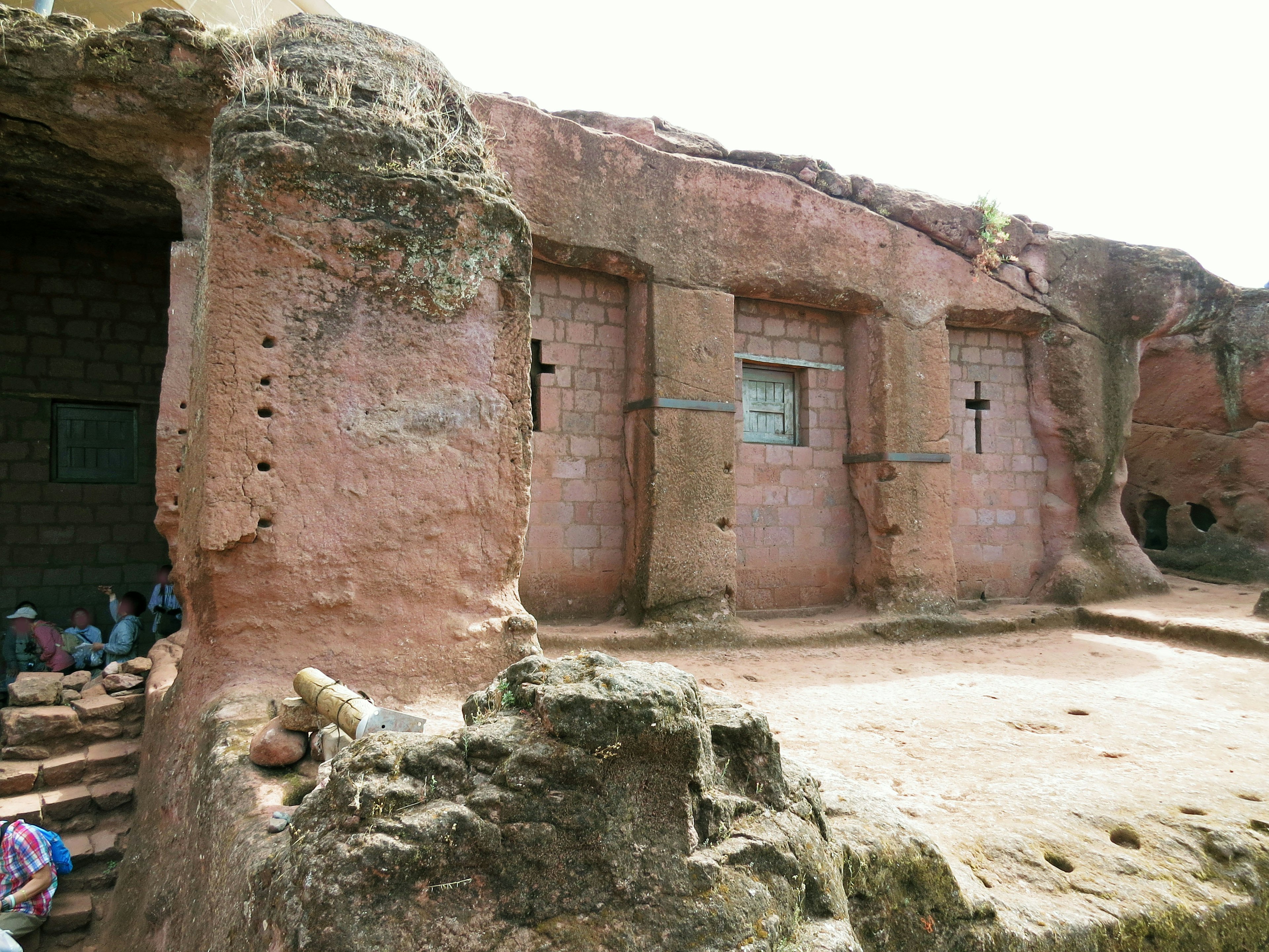 Ancient rock structure ruins with carved crosses on the walls