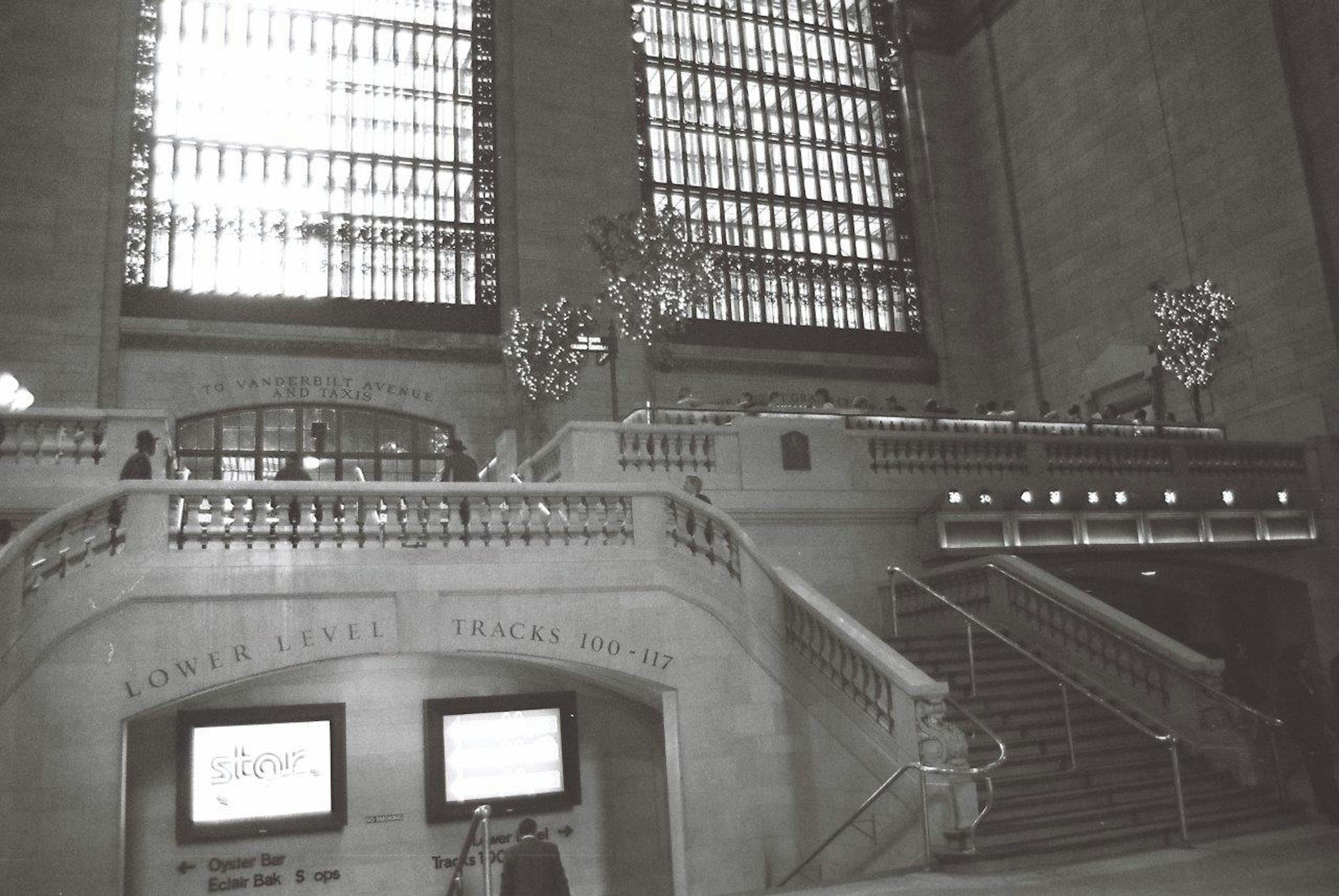 Interior view of Grand Central Station featuring large windows and staircase