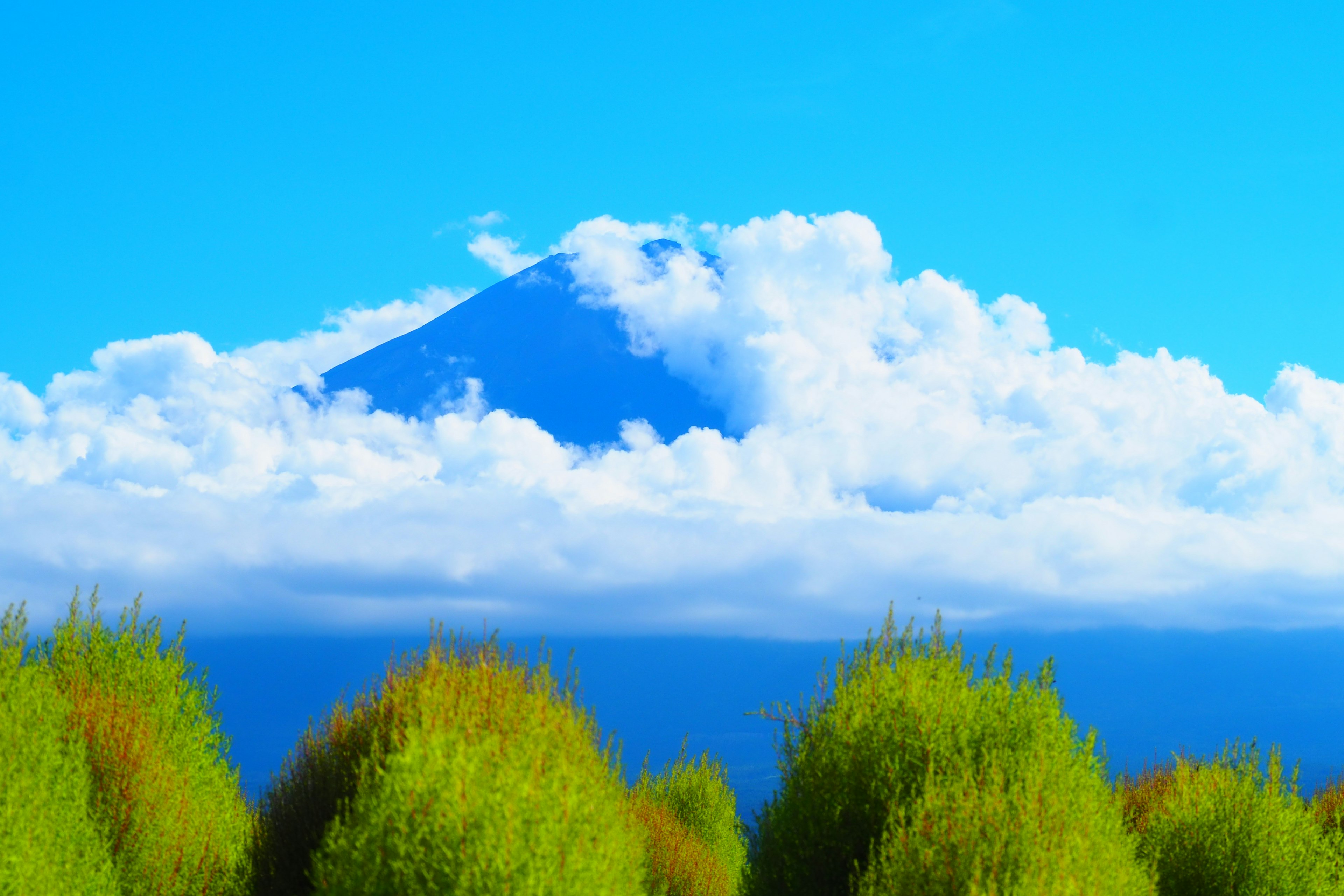 青空と雲に囲まれた山が見える美しい風景