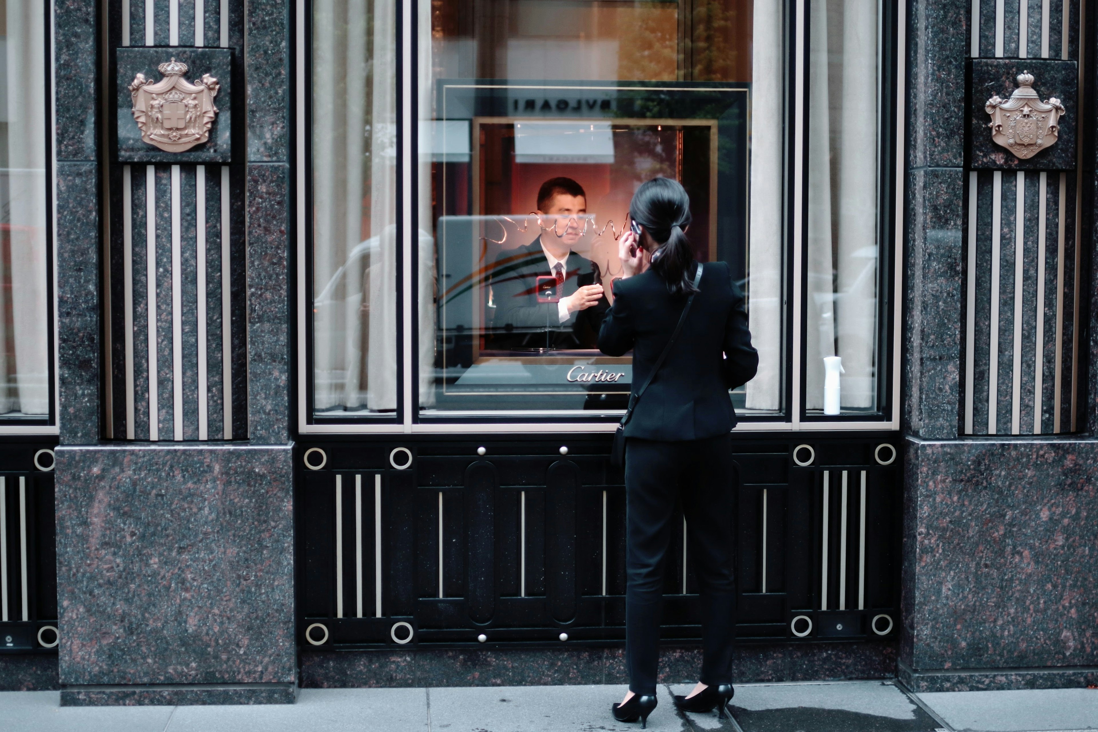 A woman talking to a man through a window