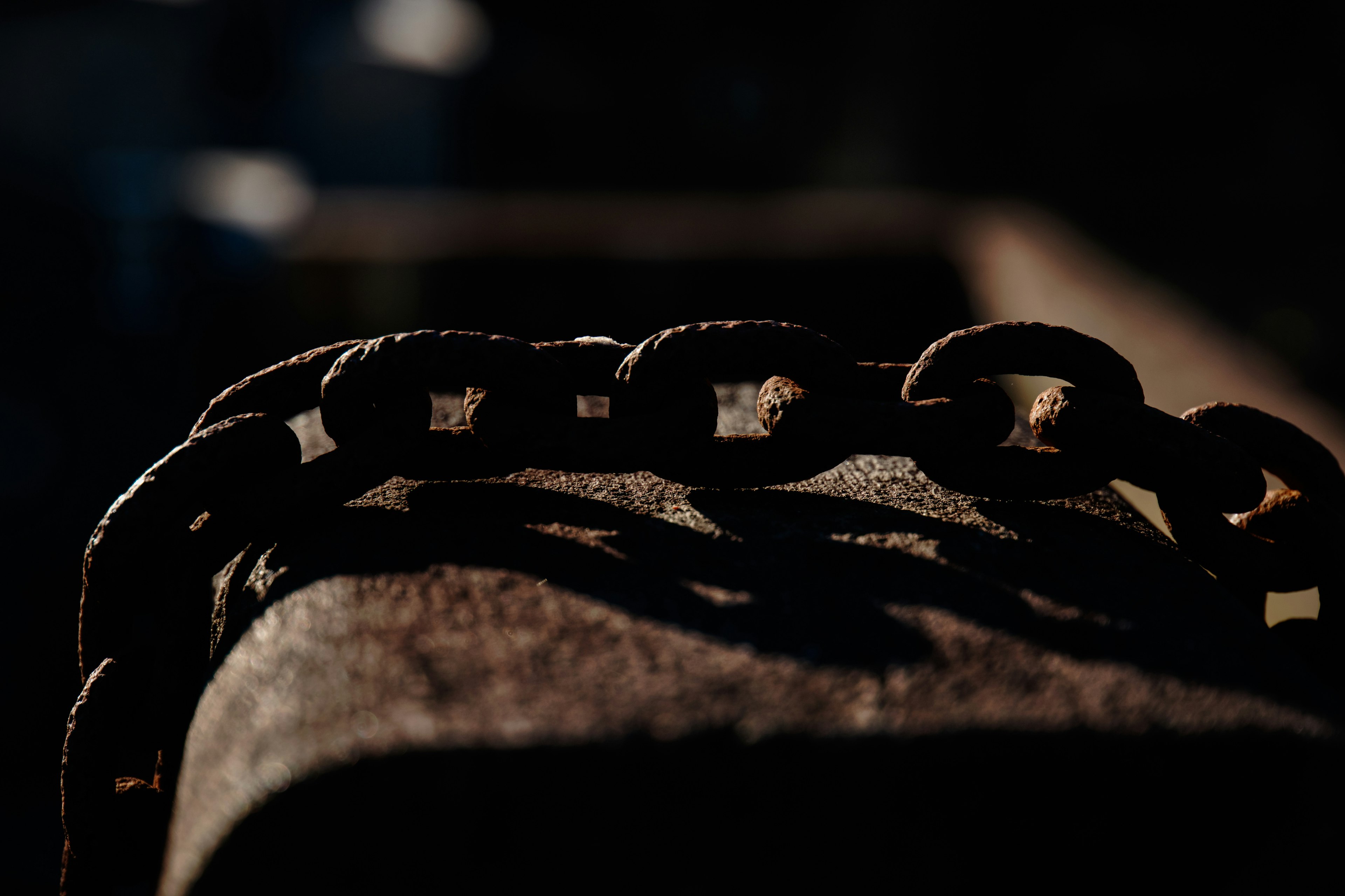 Image featuring a weathered chain highlighted against a dark background