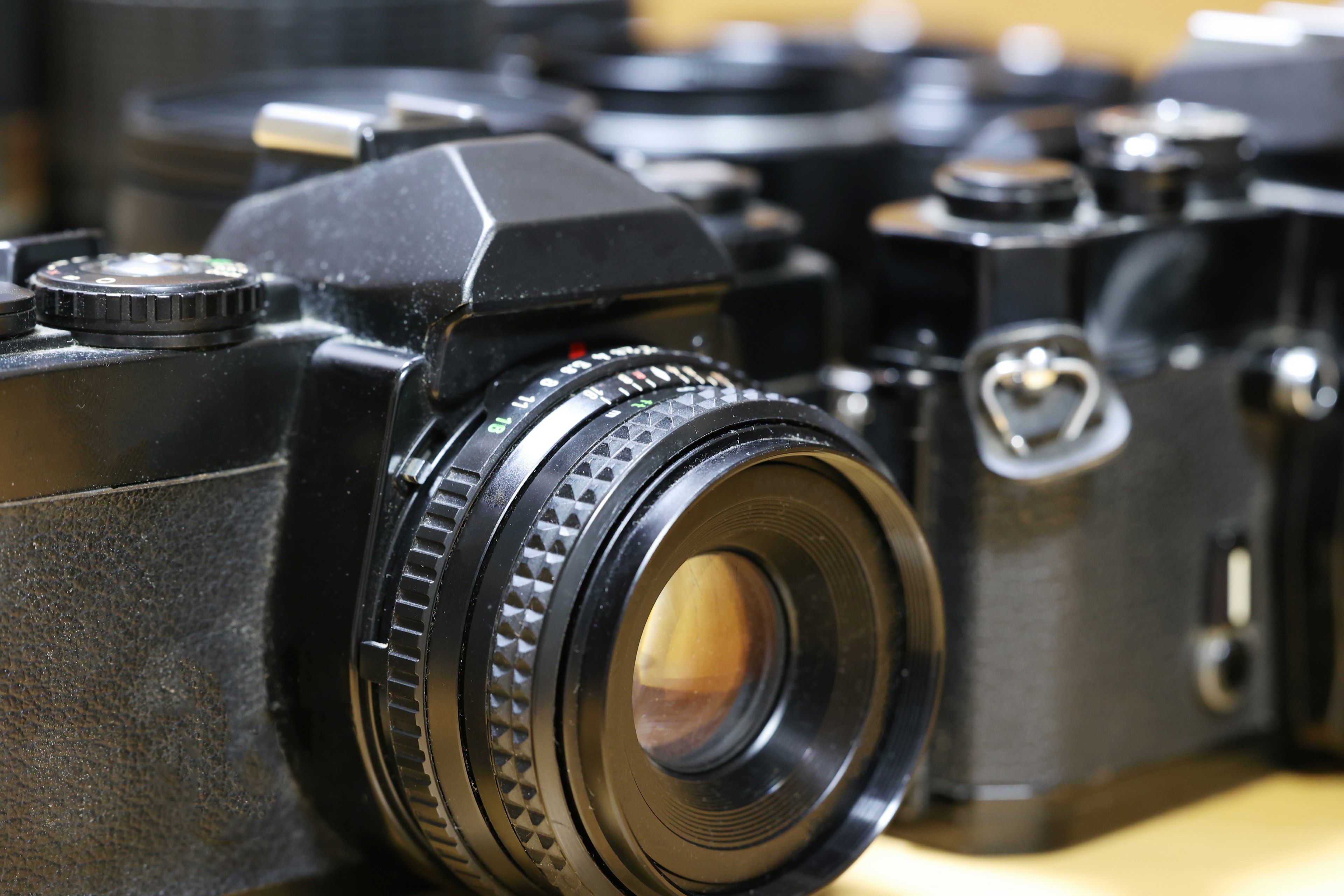 Close-up of a black camera among several others