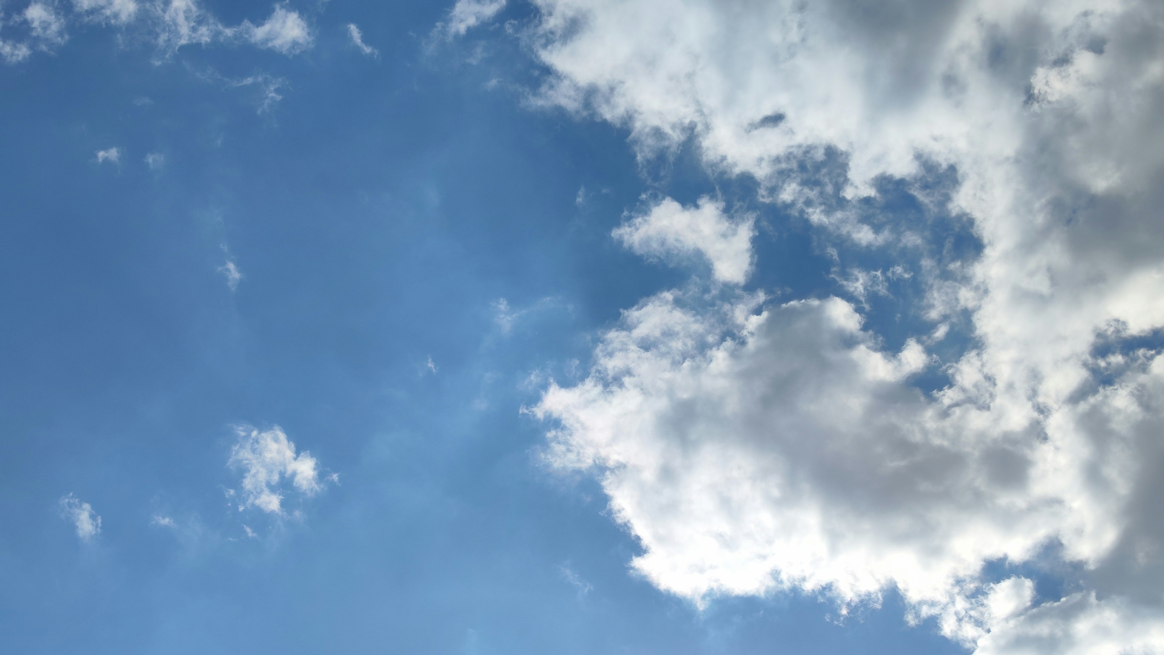 Bright blue sky with fluffy white clouds