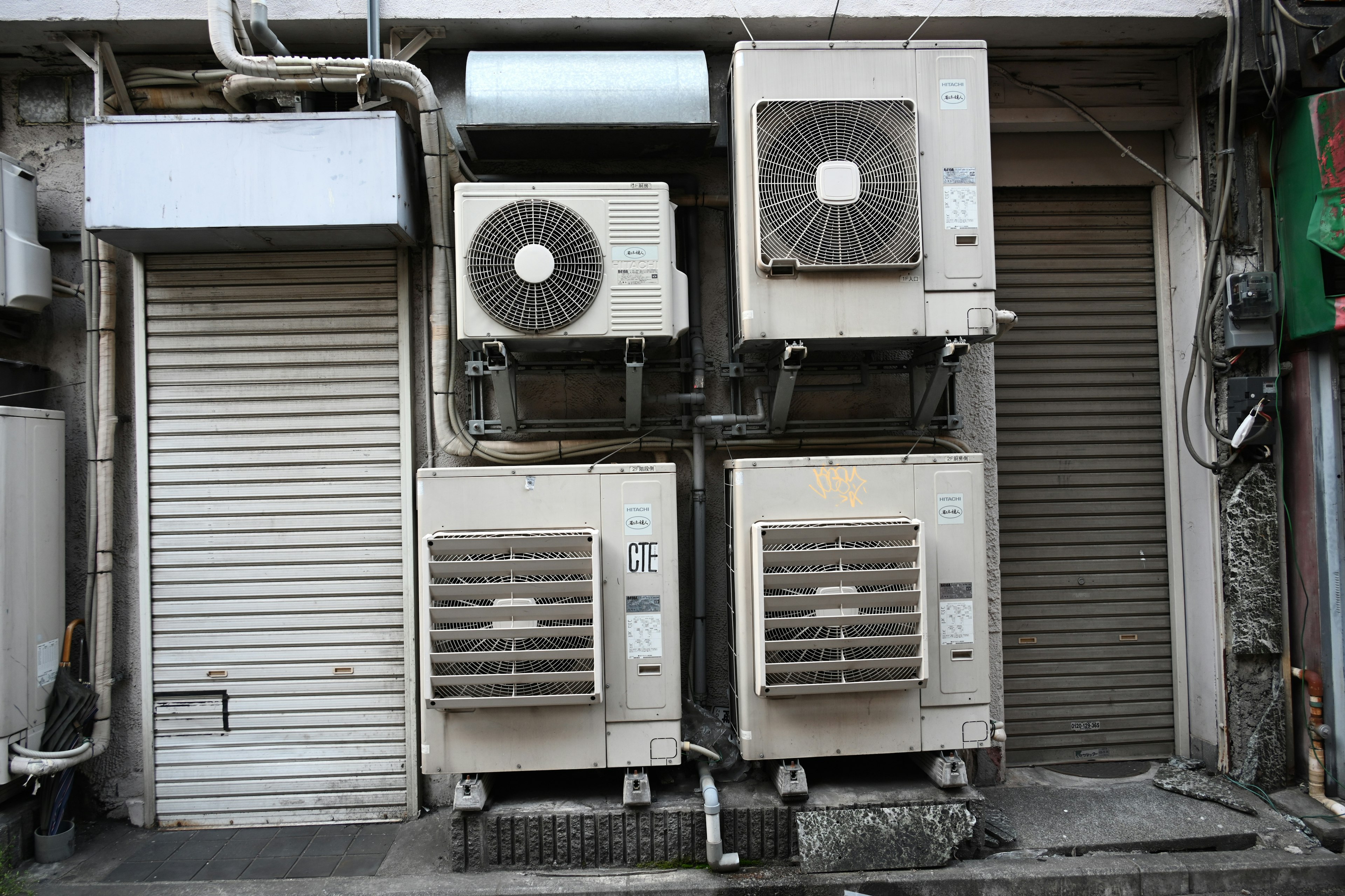 Photo of four air conditioning units mounted on an exterior wall