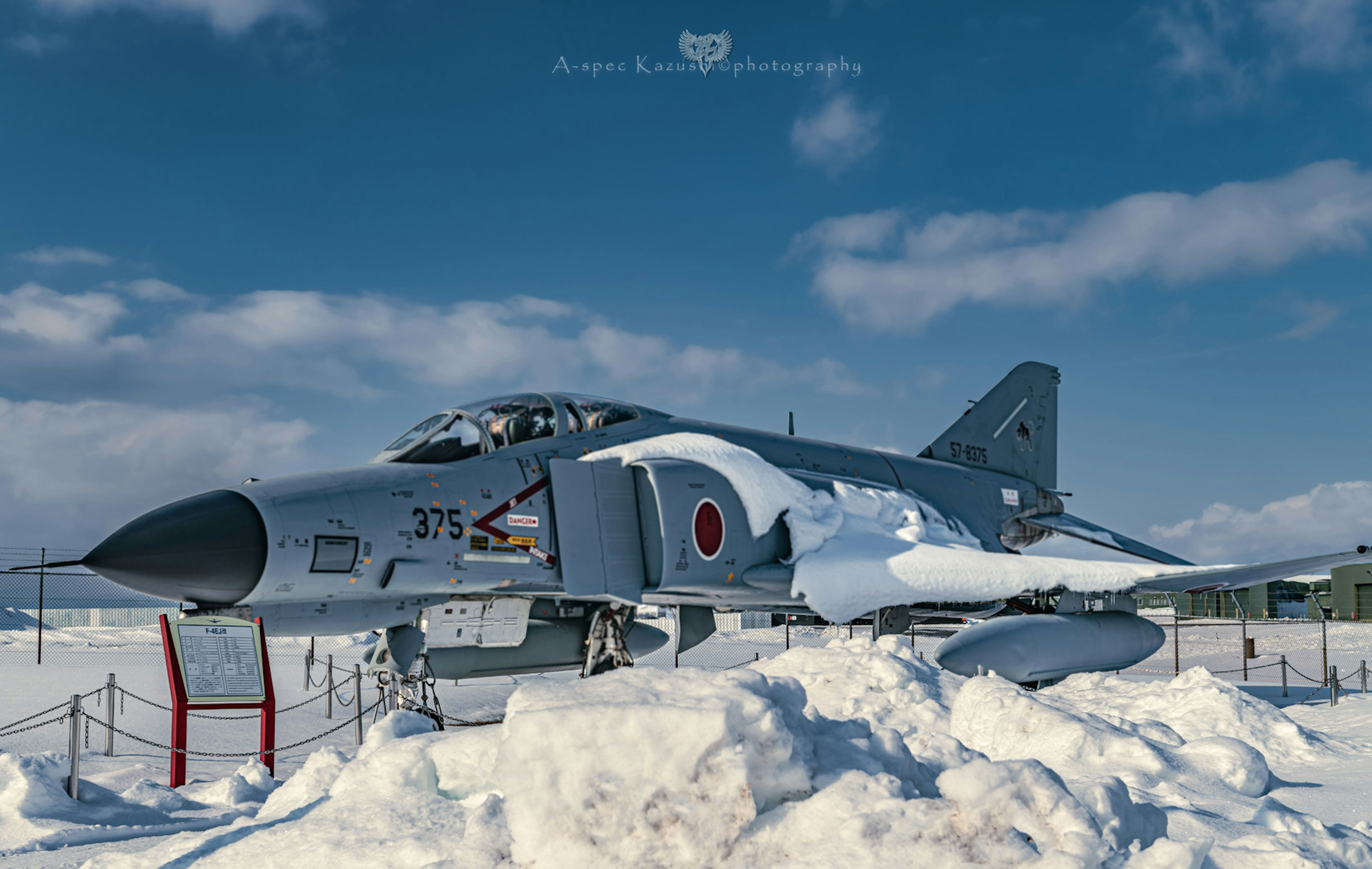 Japanese F-4 fighter jet on display surrounded by snow