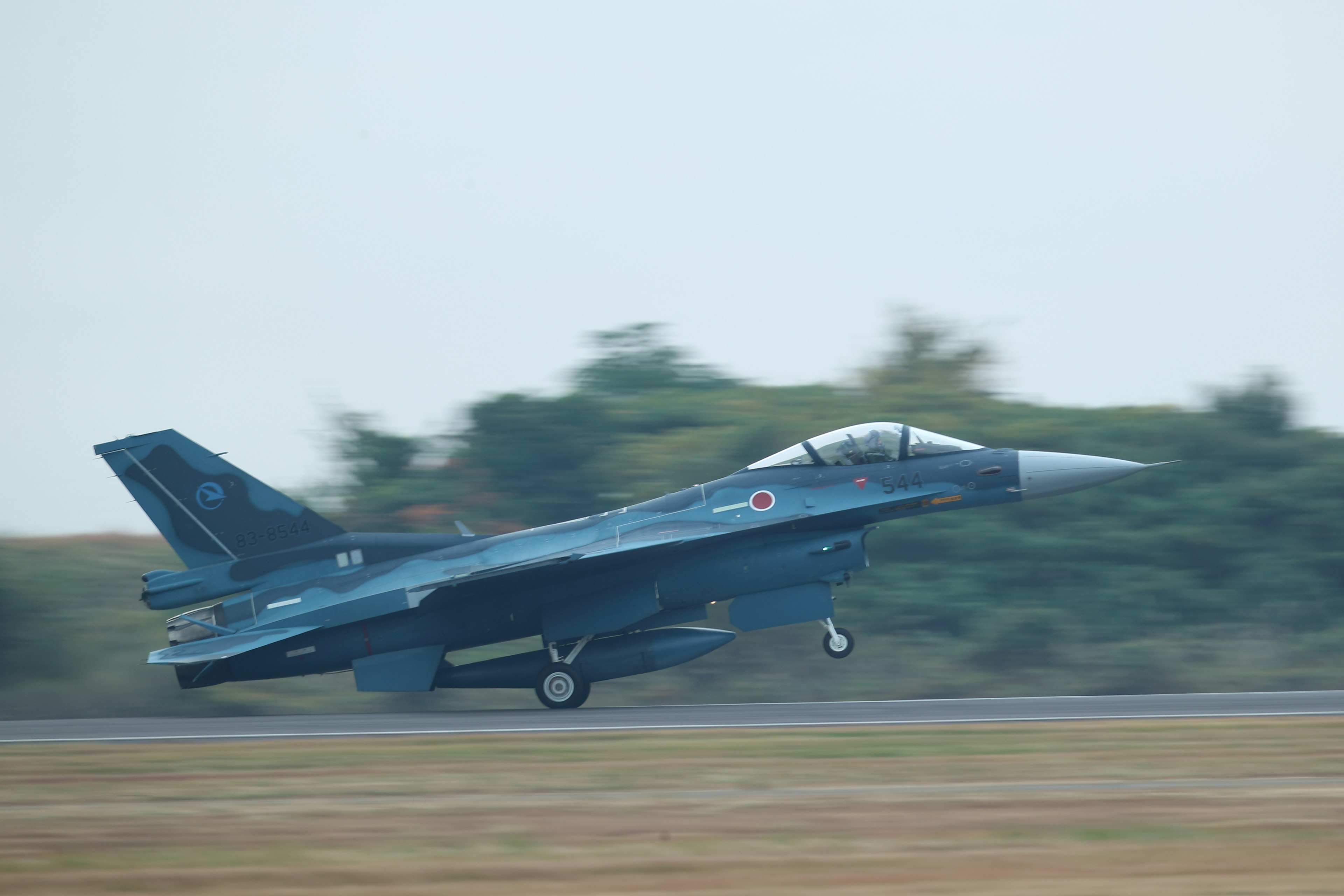 Blue fighter jet taking off from the runway