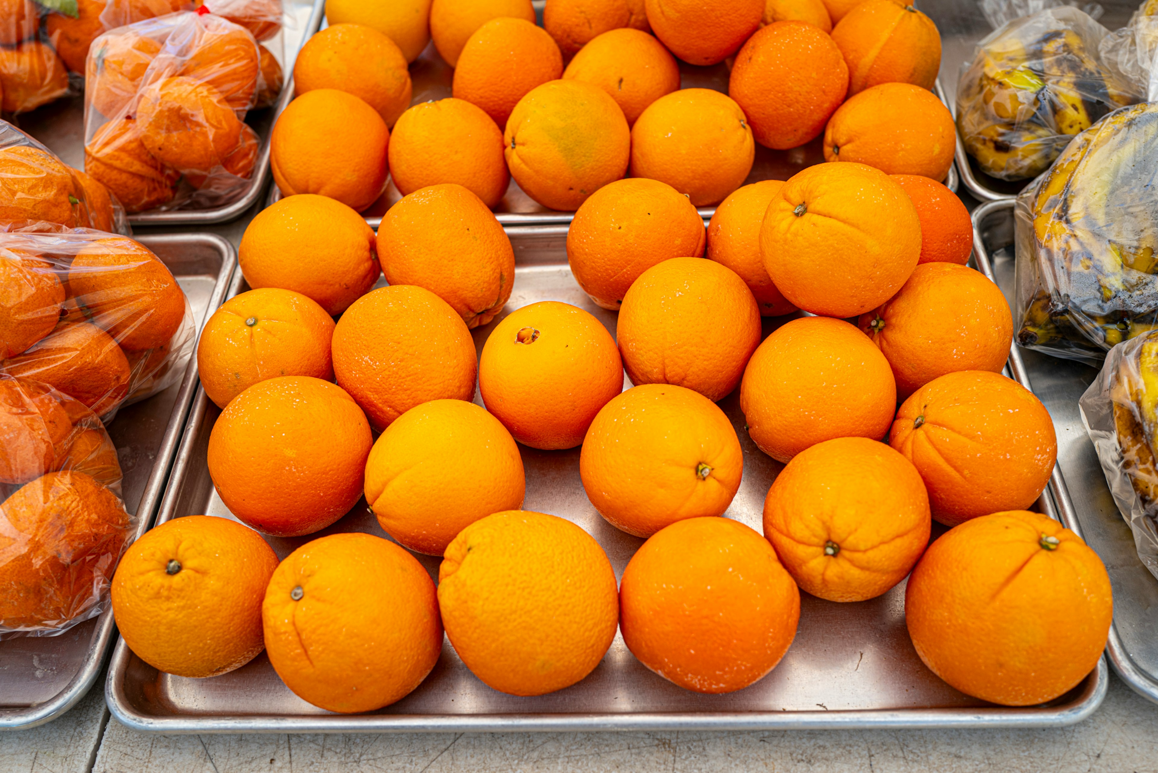 Fresh oranges arranged on a market table