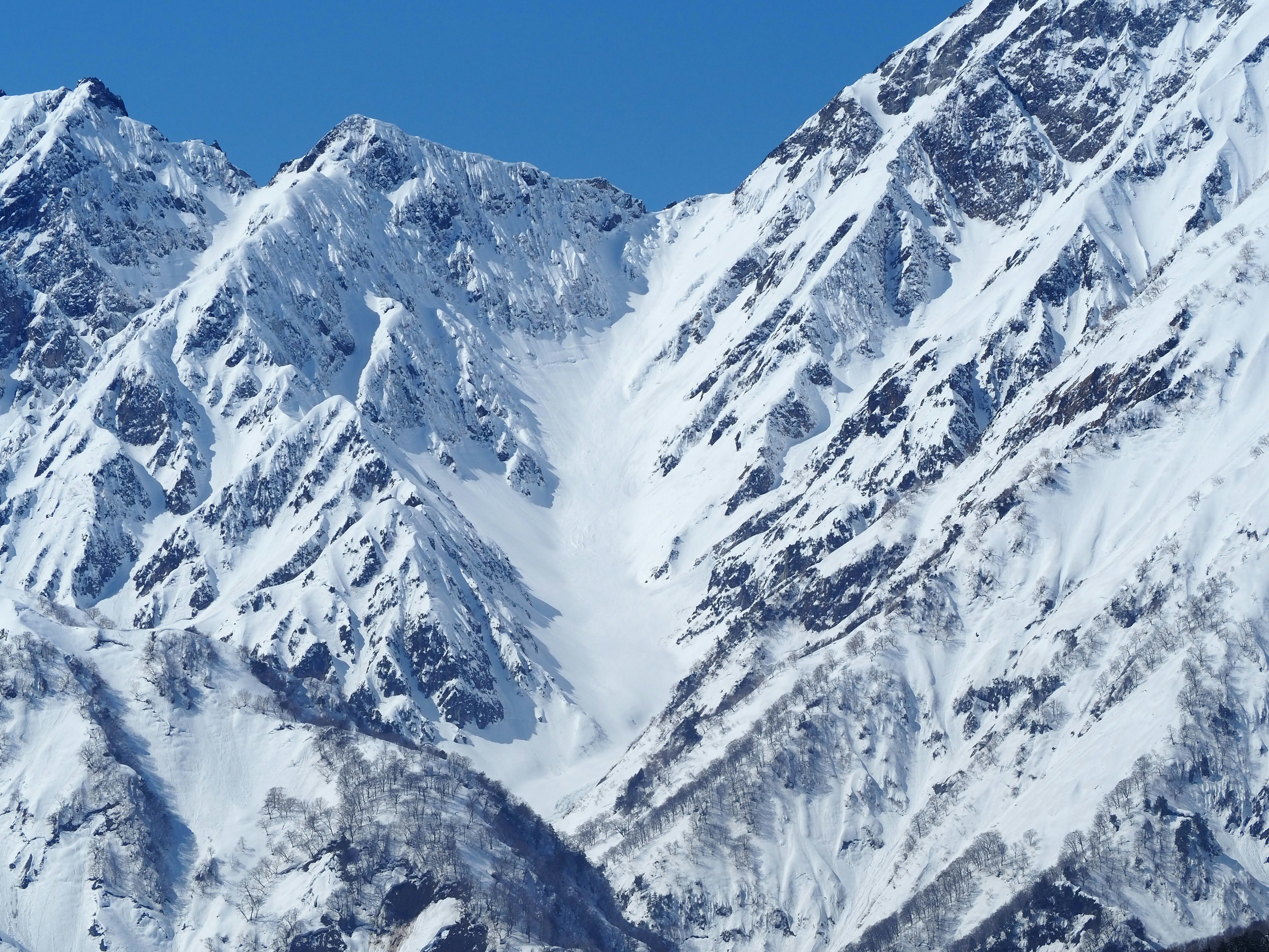 Snow-covered mountain landscape bright blue sky and contrast with snow