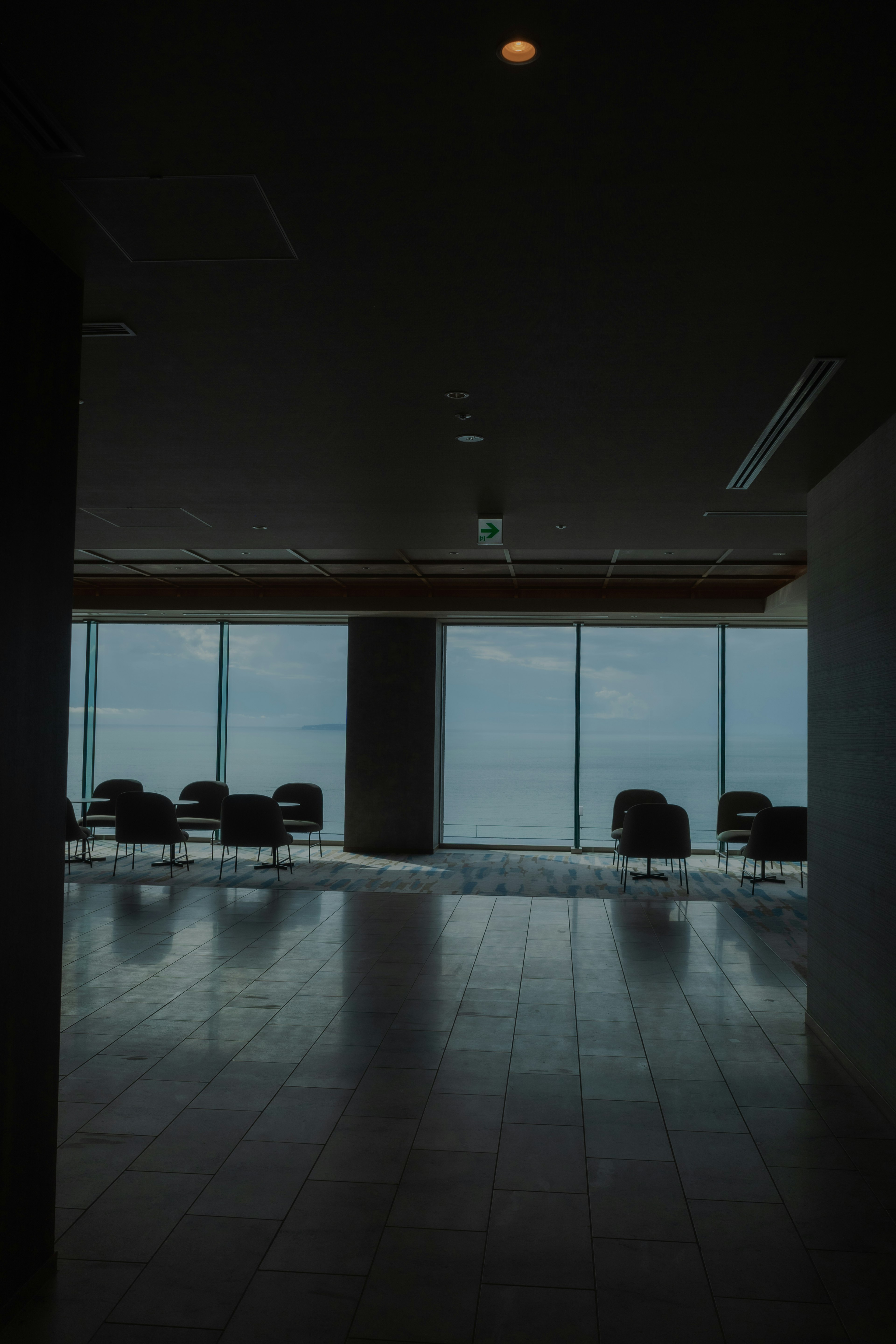 Spacious interior with a view of the sea and chairs