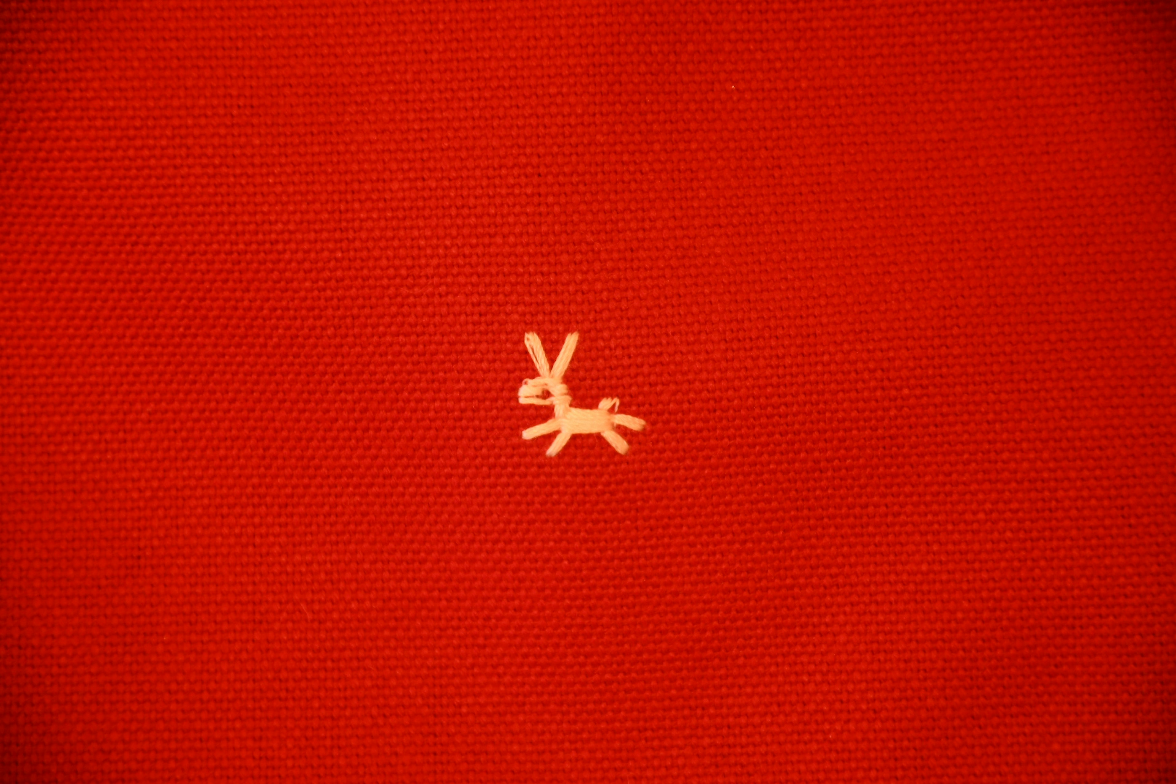 Small yellow figure on a red background