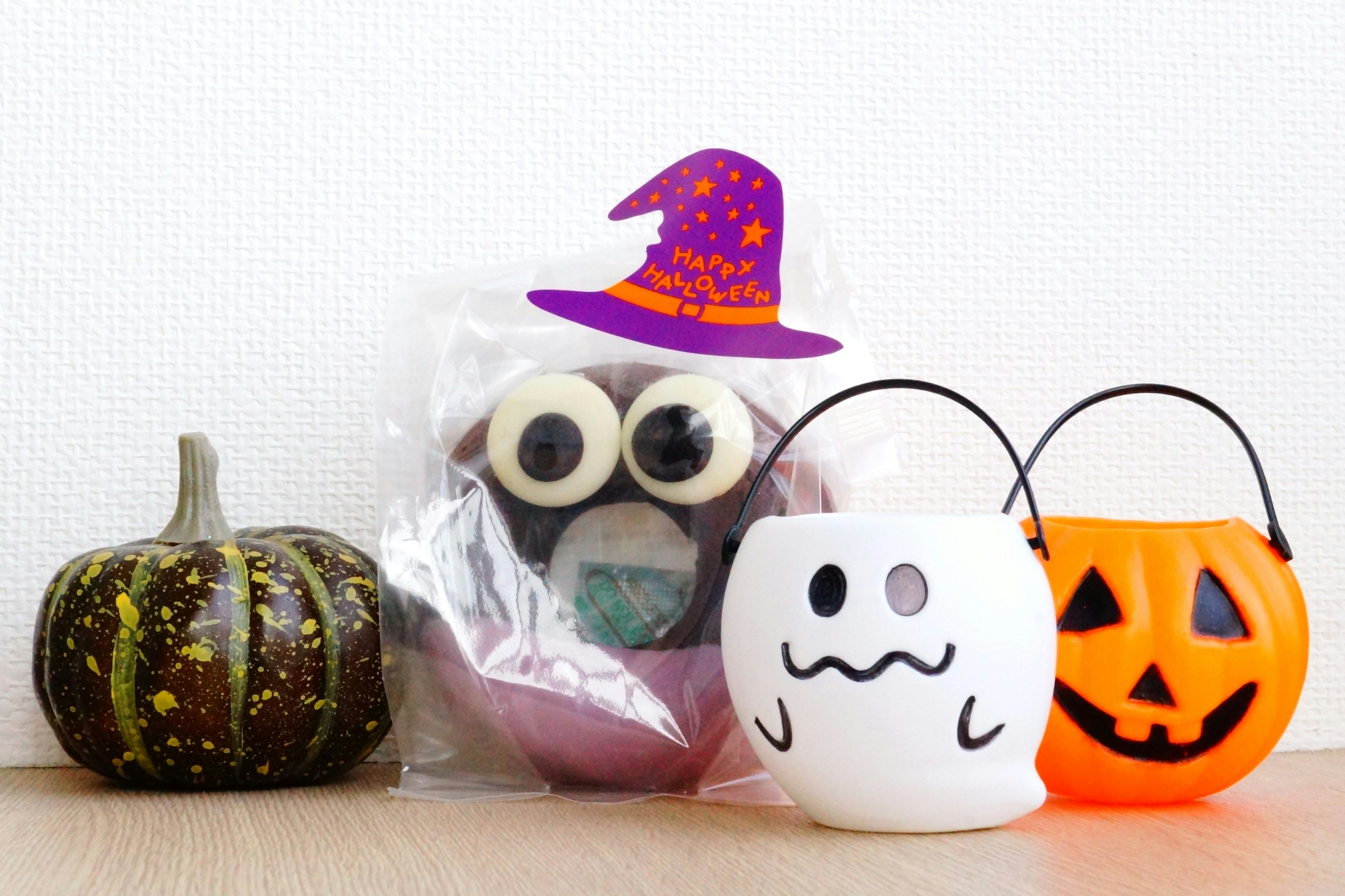 Colorful Halloween decorations including pumpkin and candy buckets