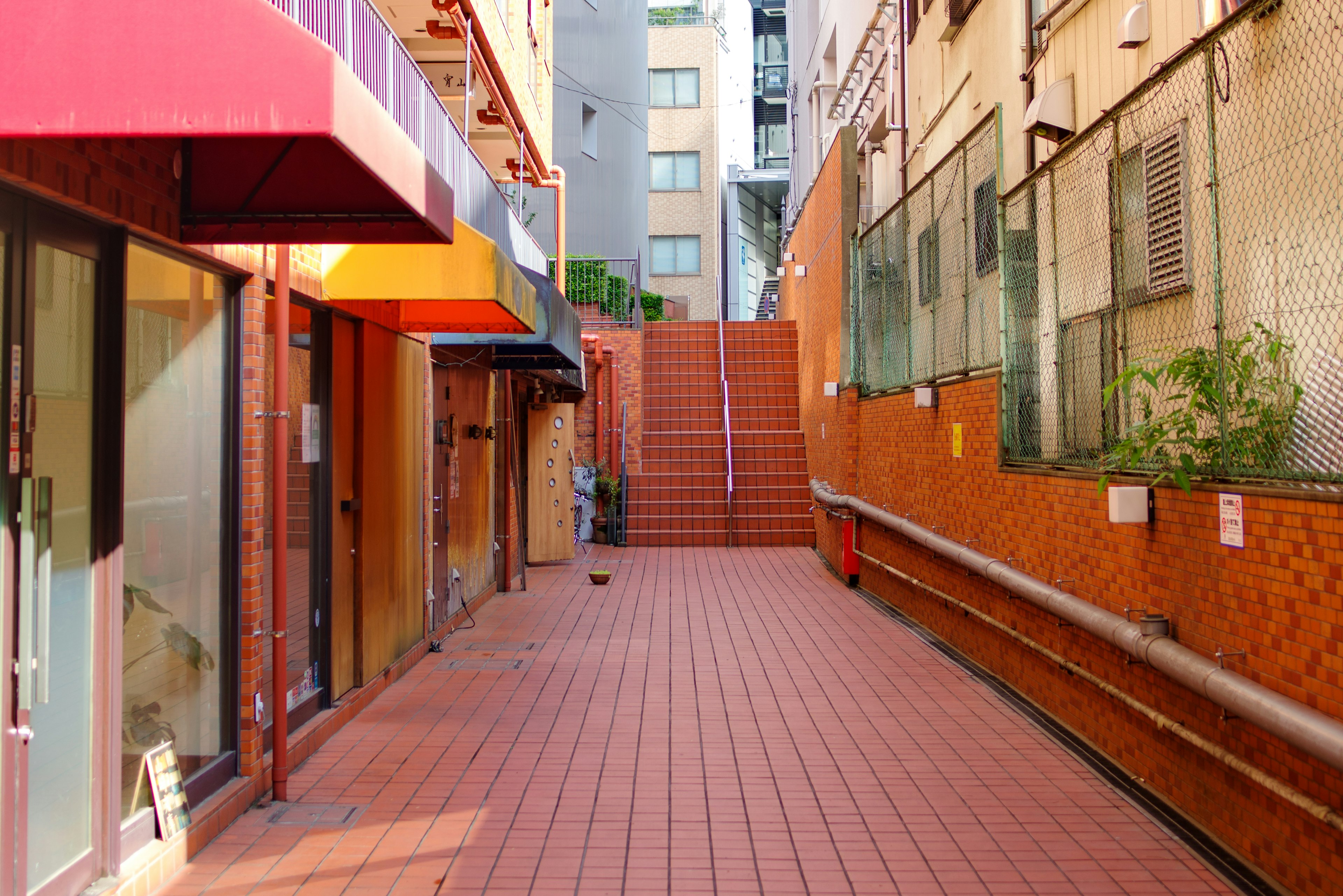 Scène de rue urbaine avec un chemin en carreaux rouges et des escaliers