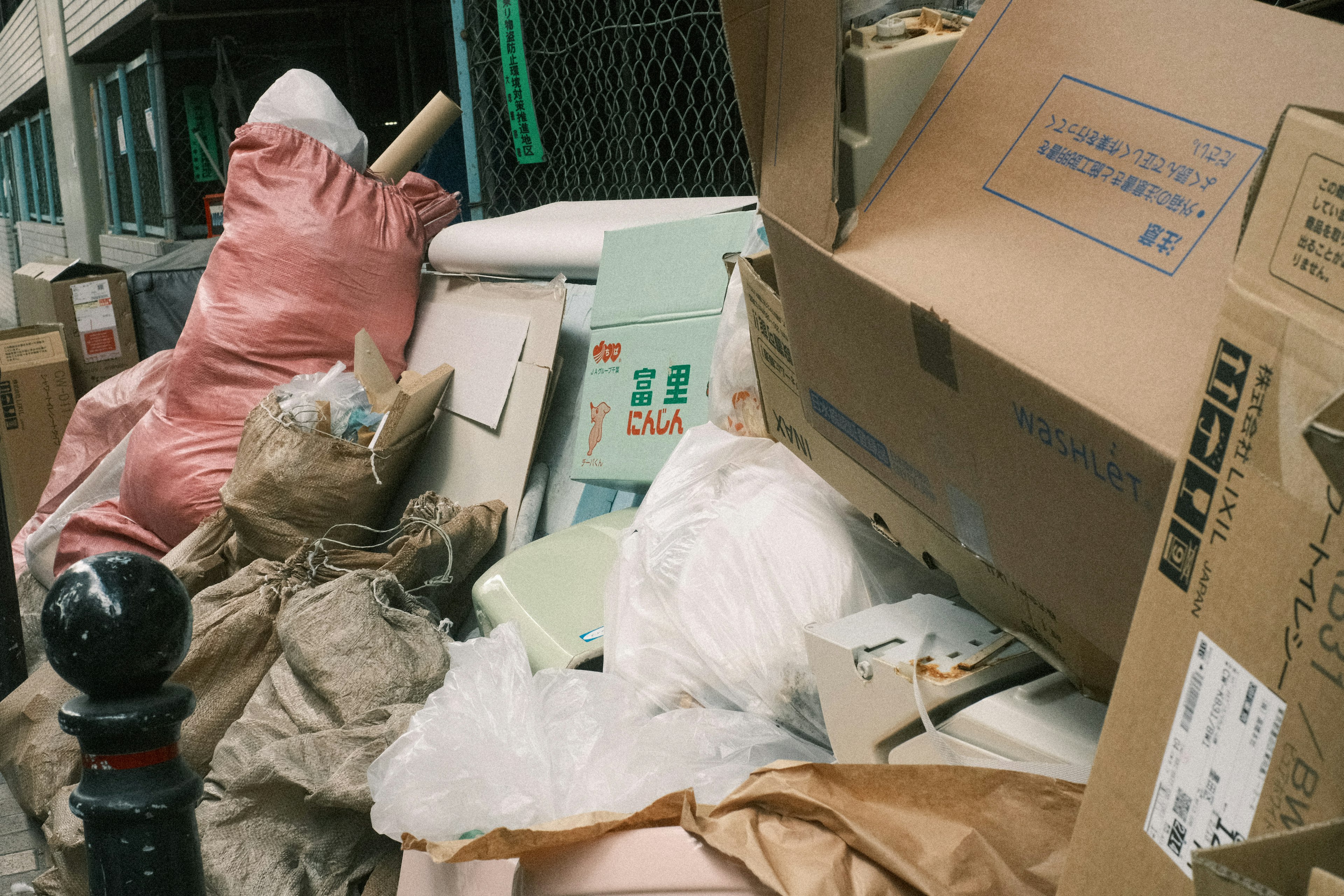 A pile of discarded waste and cardboard boxes on the street