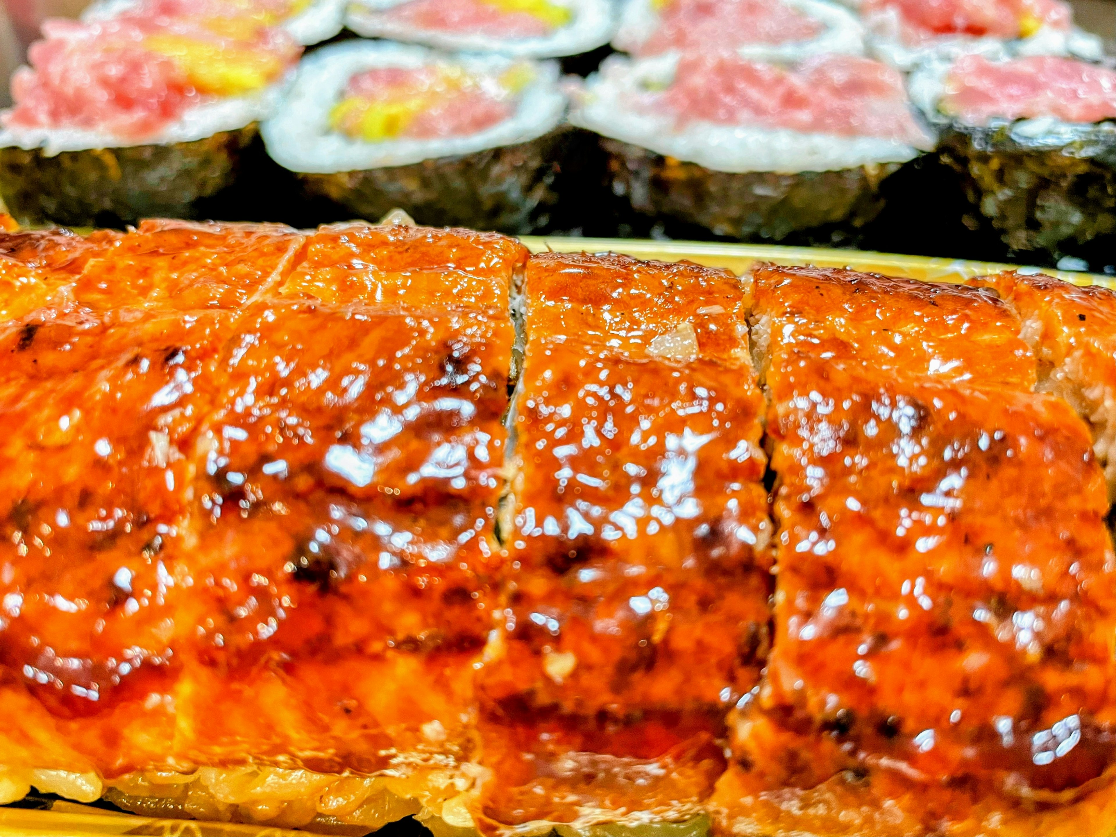 A plate of delicious grilled fish and sushi rolls