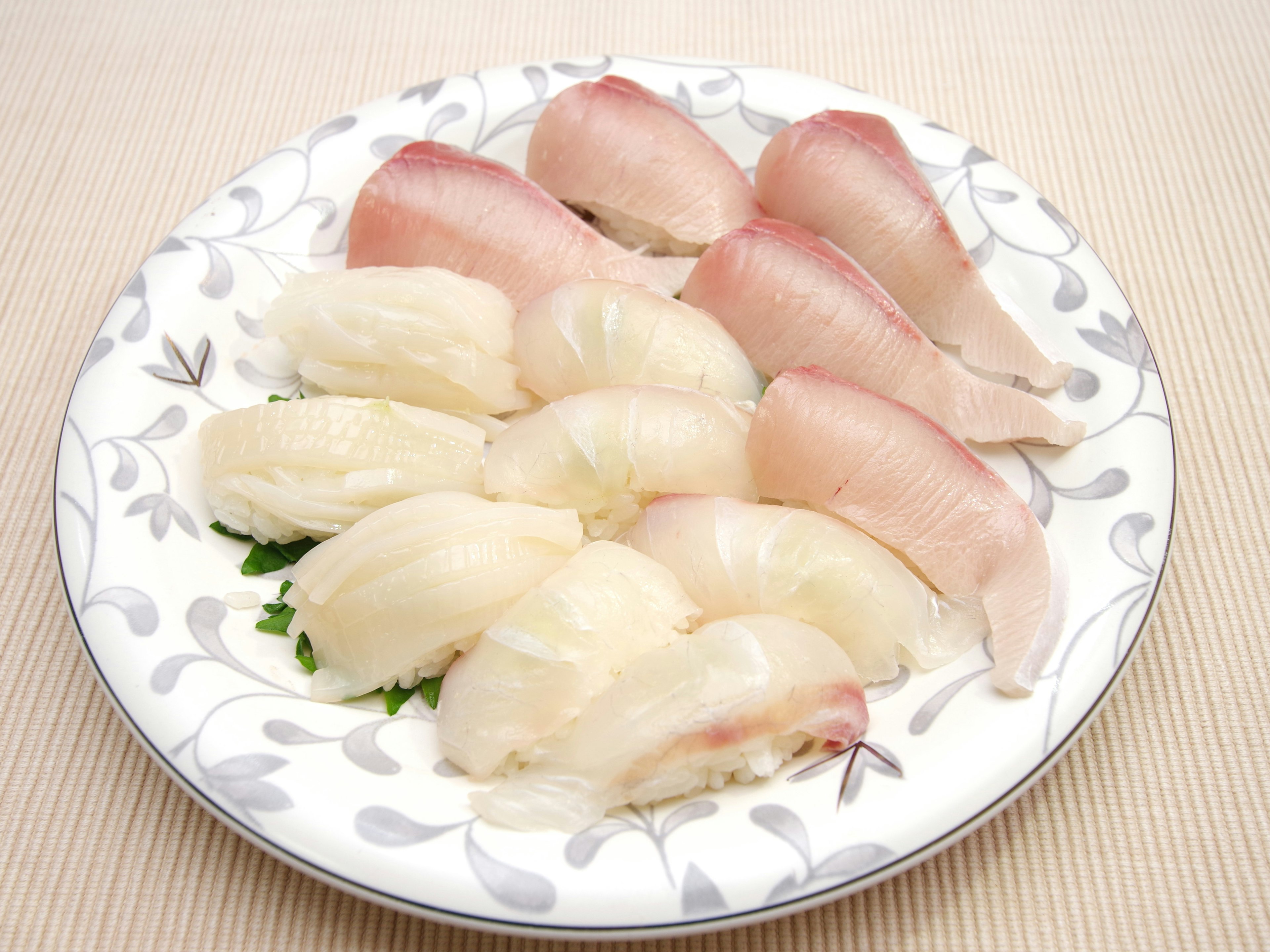 An assortment of sushi arranged on a decorative plate