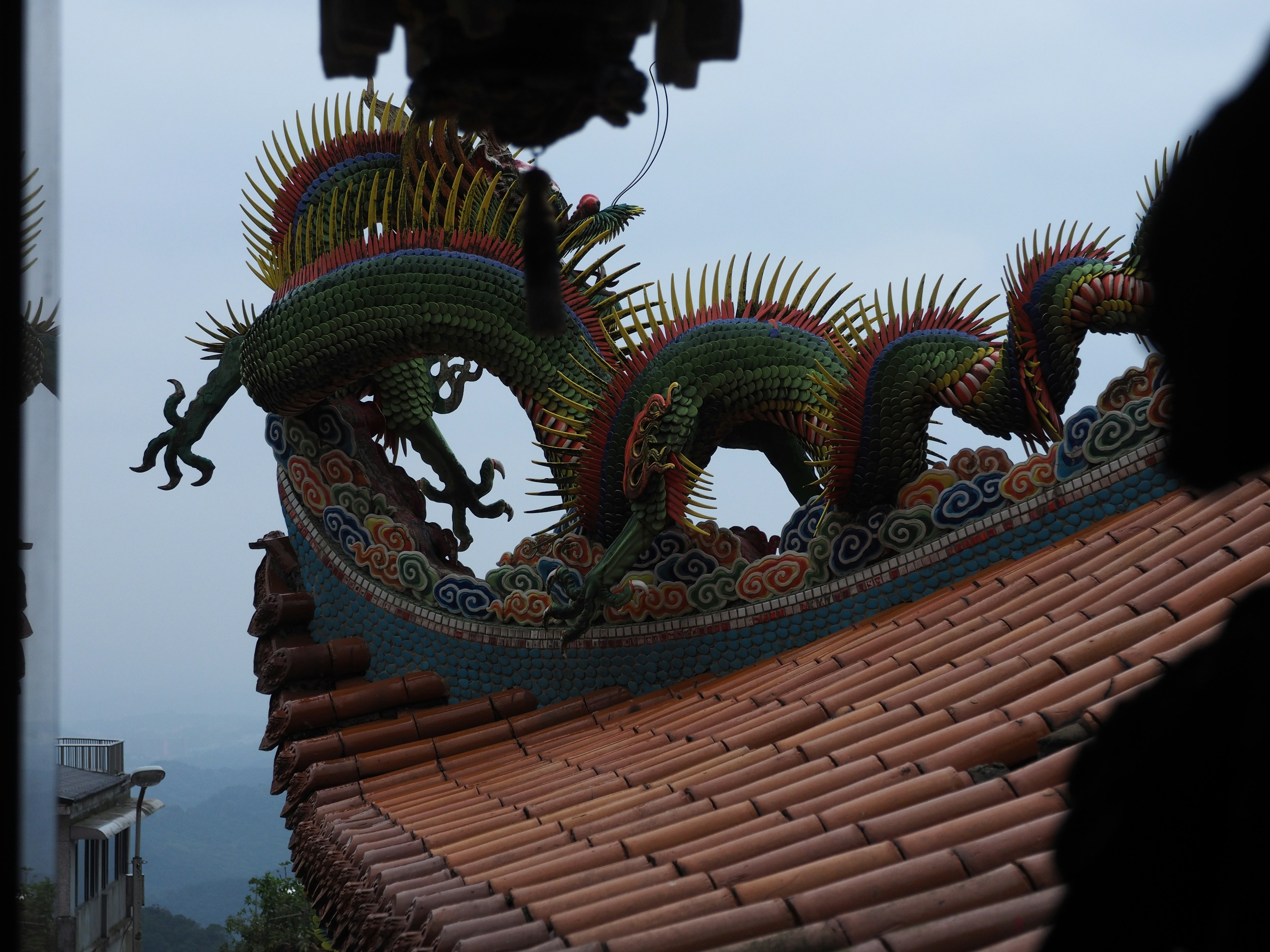 Image of a colorful dragon decoration on a rooftop