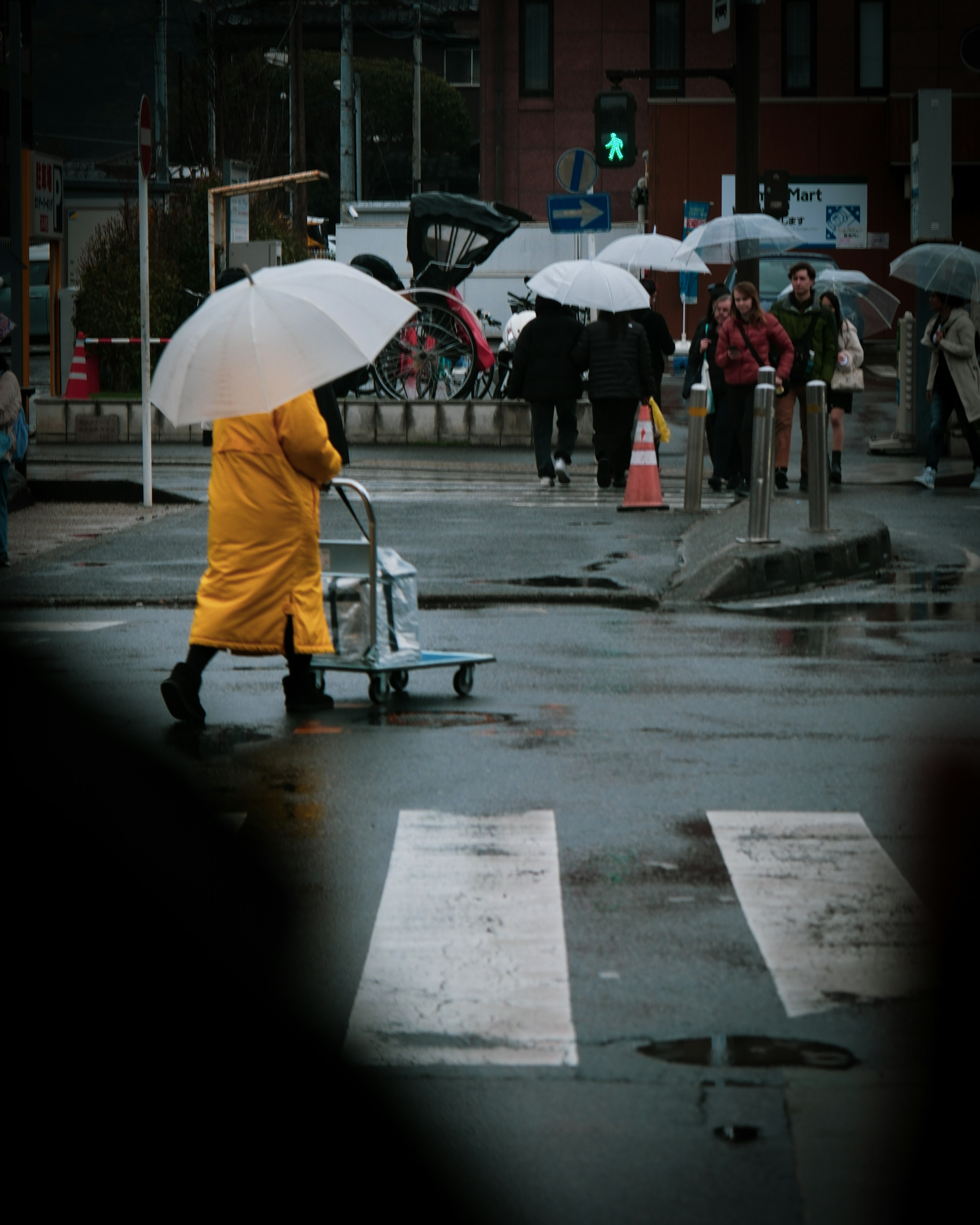 一个穿着黄色雨衣的人在雨中撑着伞