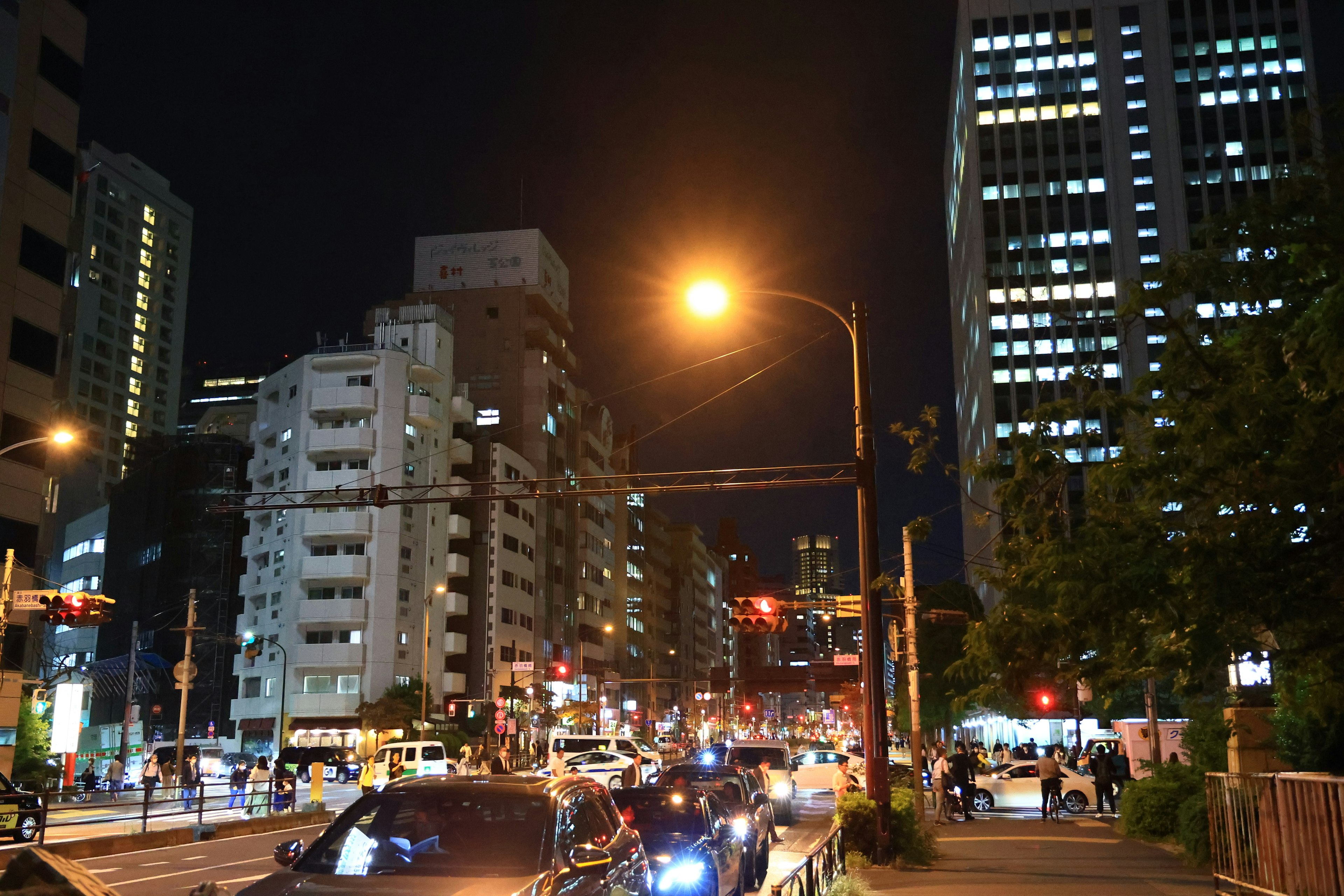 Night cityscape with bright streetlights and towering buildings