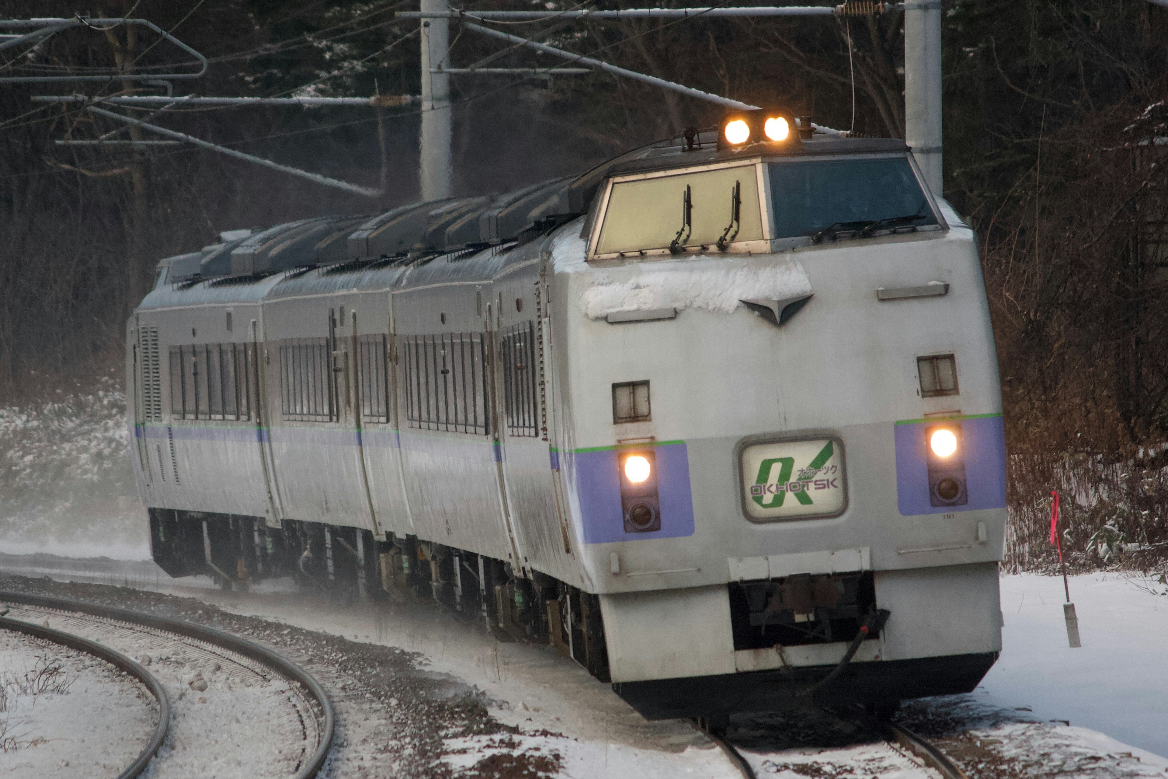 Japanese express train navigating a curve in the snow