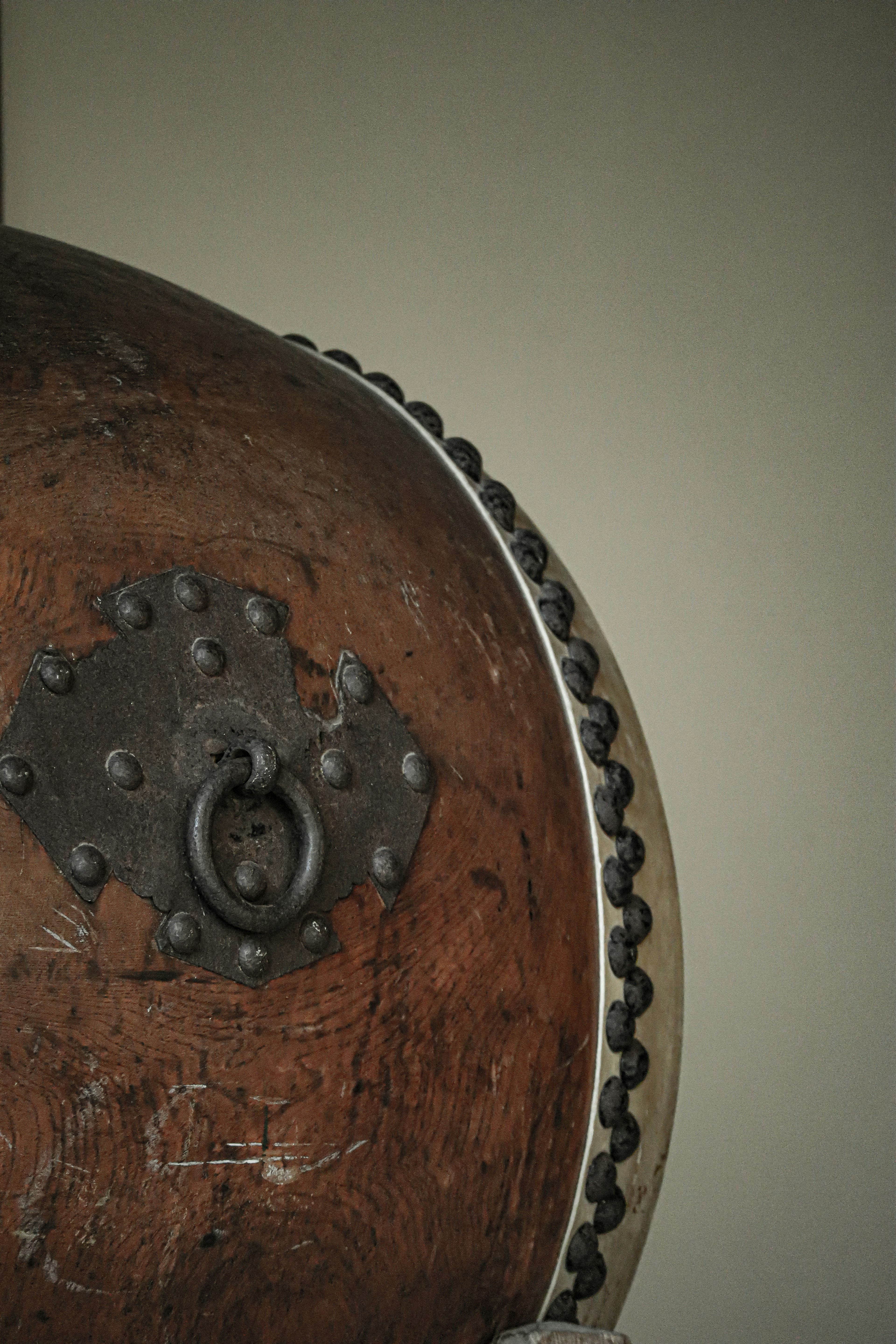 Image of a wooden shield featuring a lock and metal details