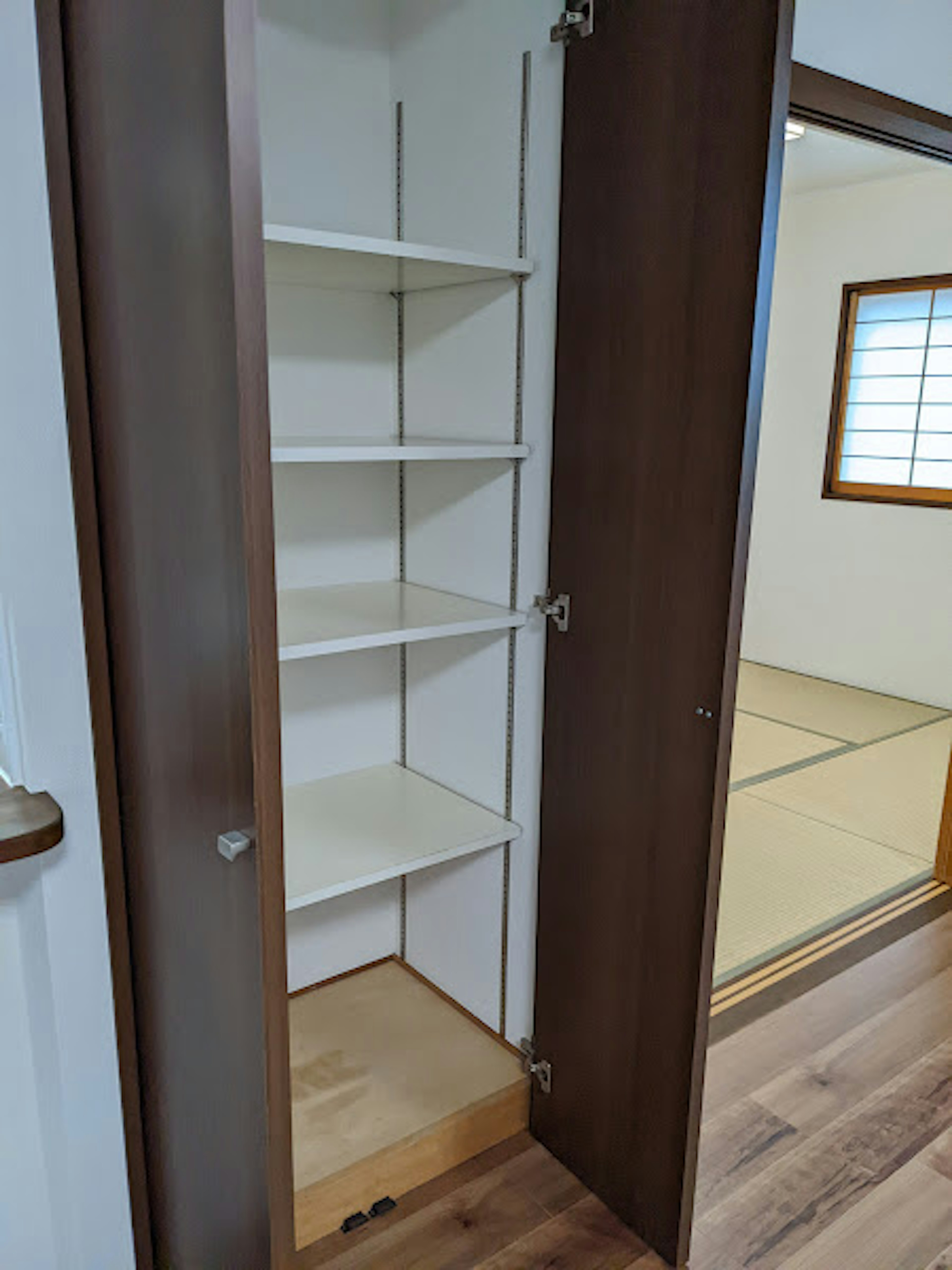 Interior of a wooden closet with white shelves