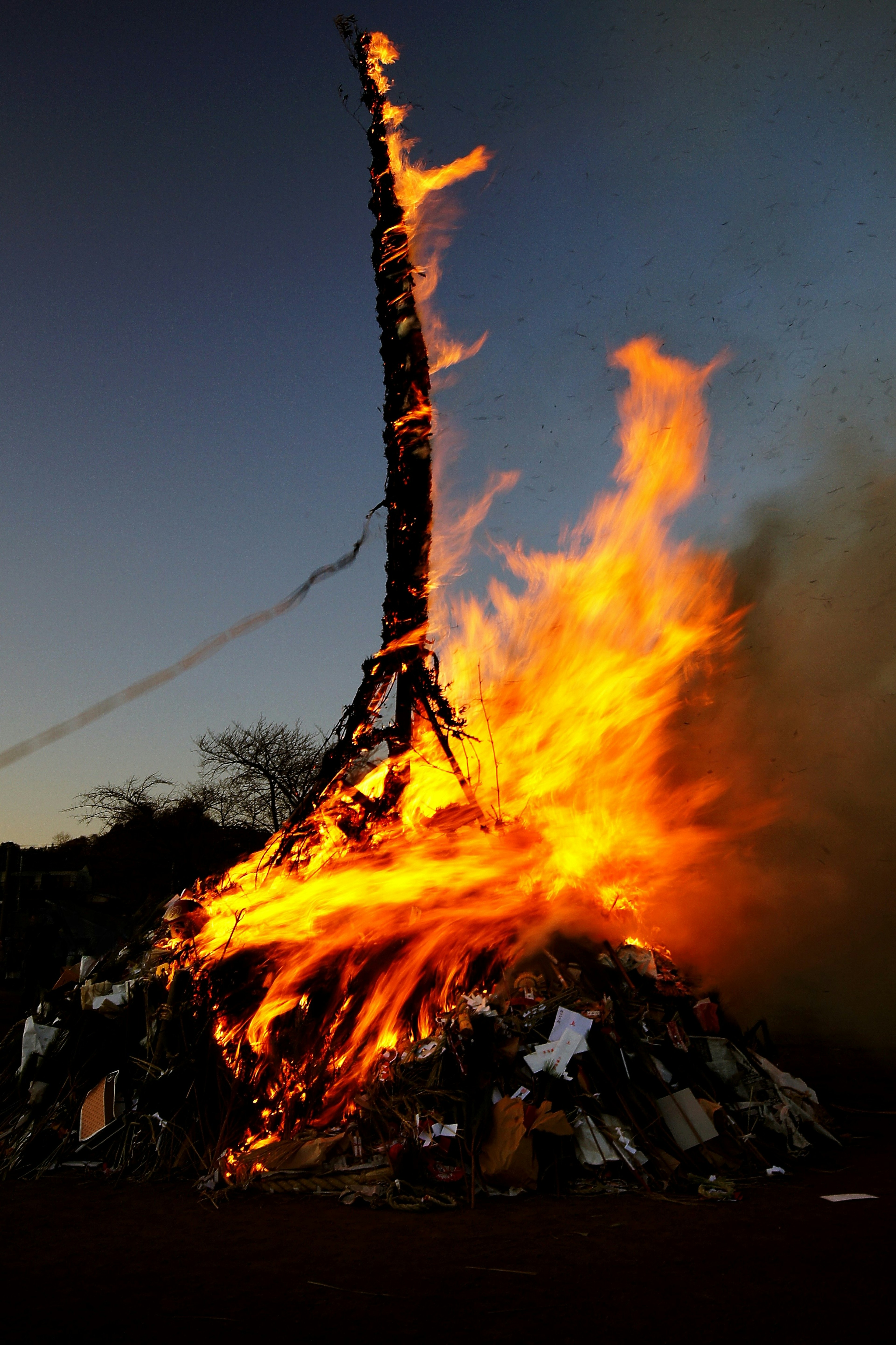 Large bonfire with flames and smoke rising