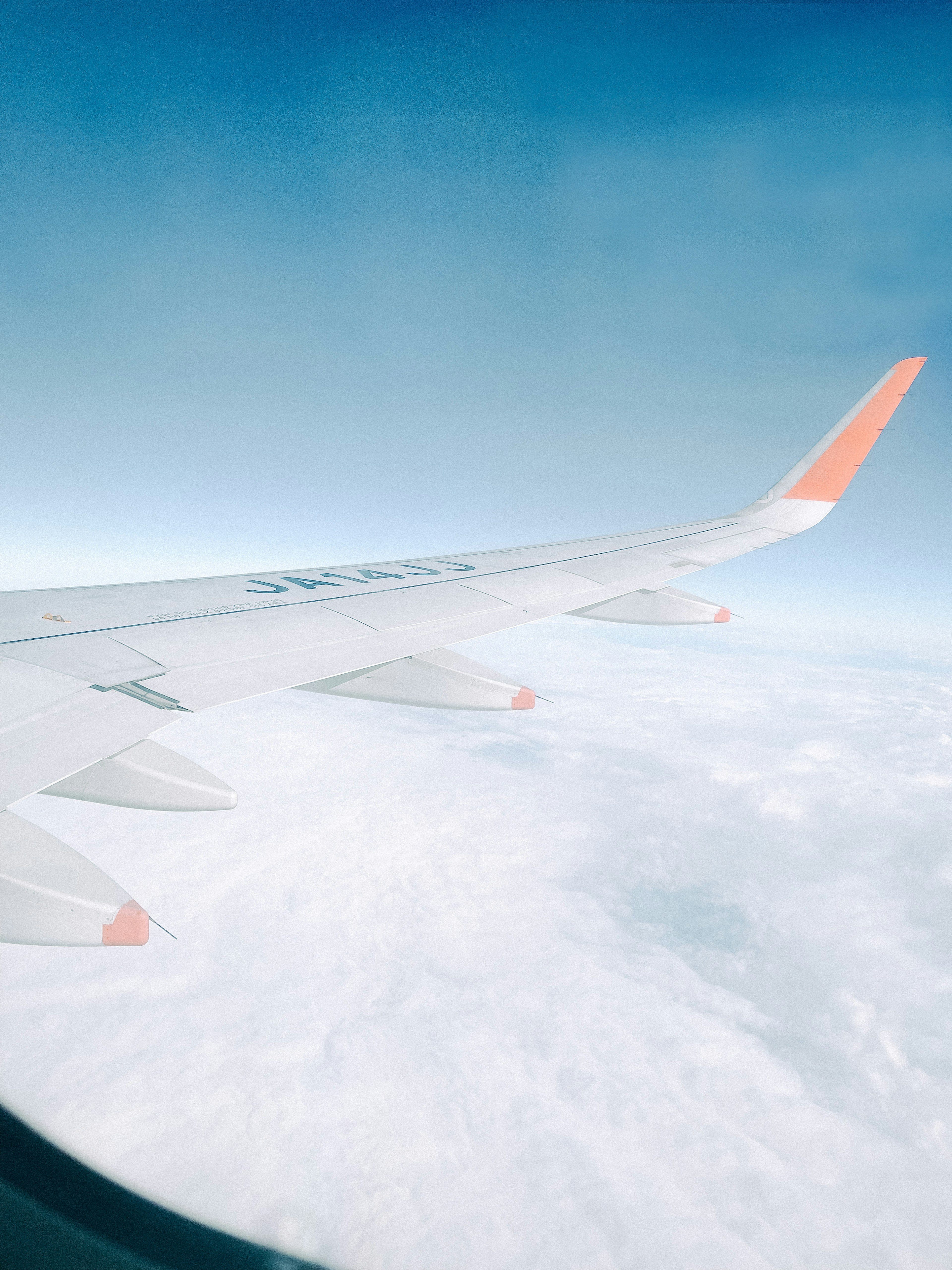 Airplane wing against a blue sky