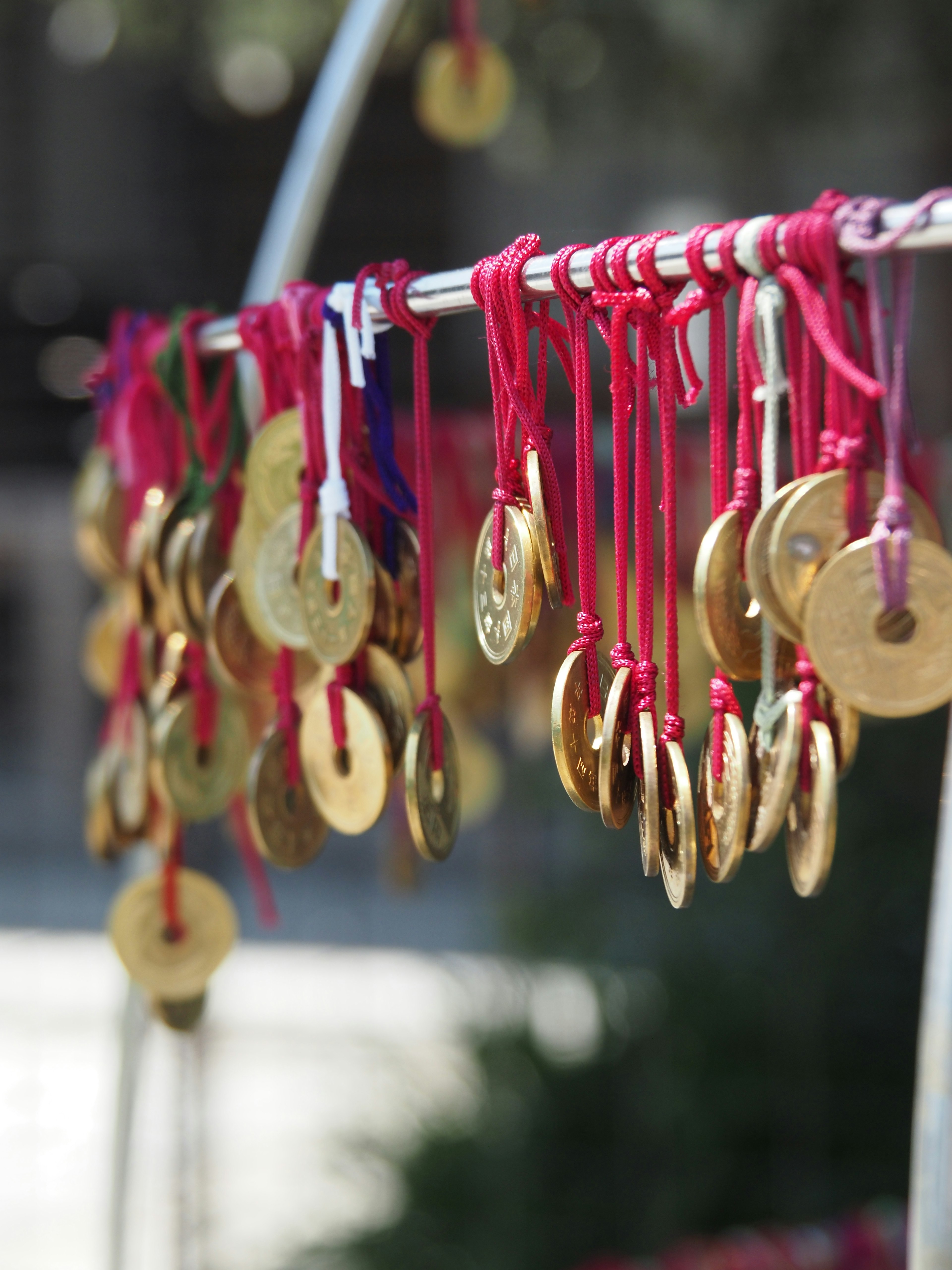 Golden coins hanging from red strings