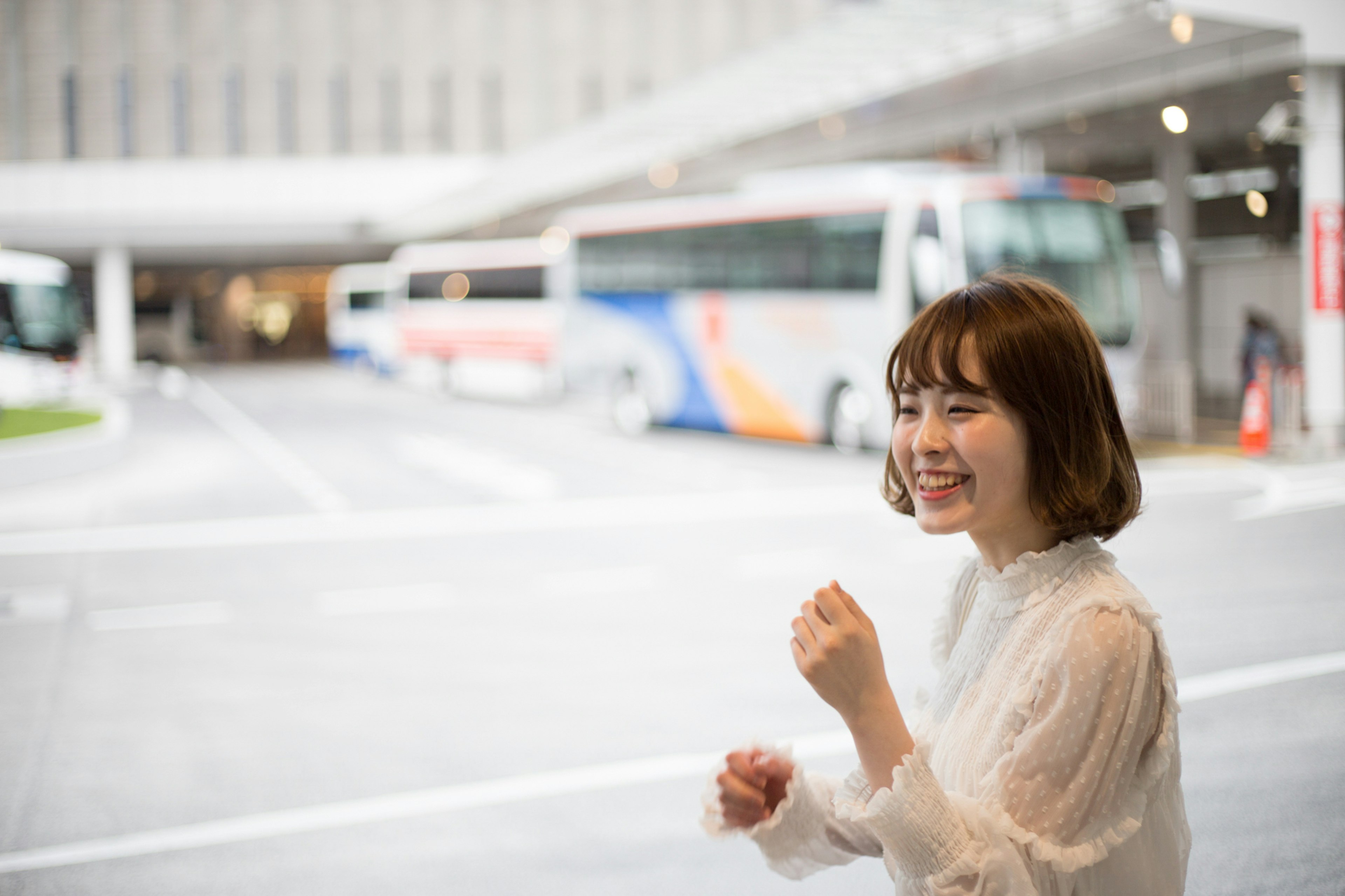 Smiling woman expressing joy at a bus station