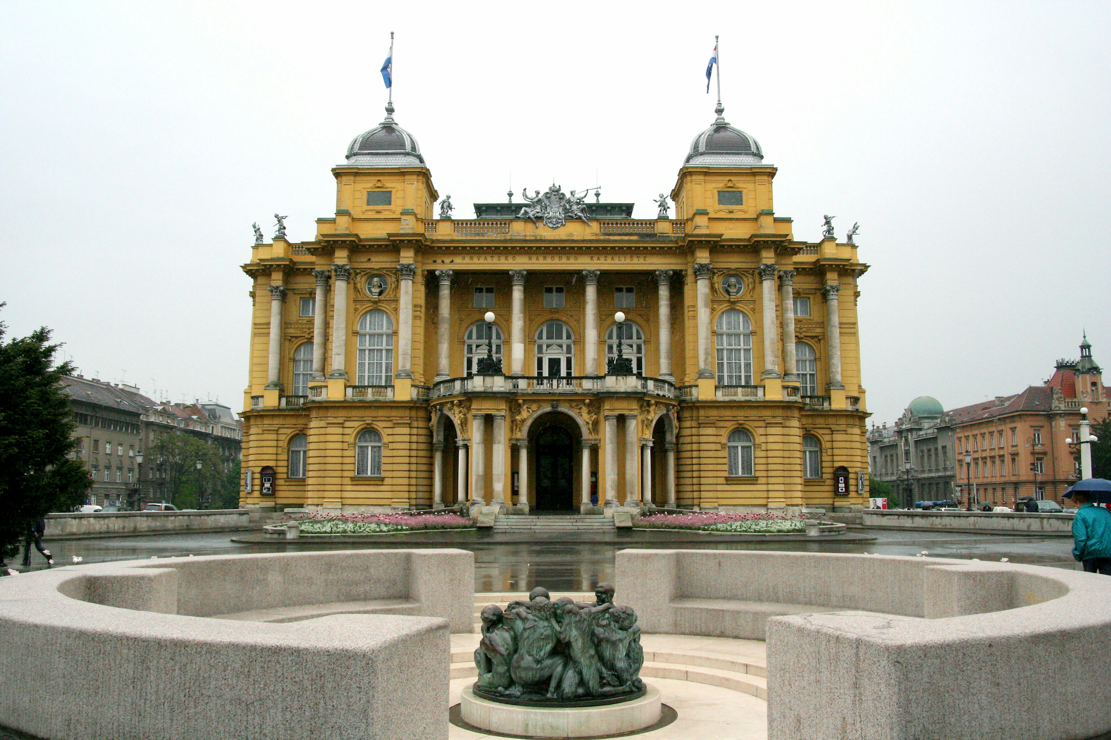 Zagreb's yellow theater with fountain view