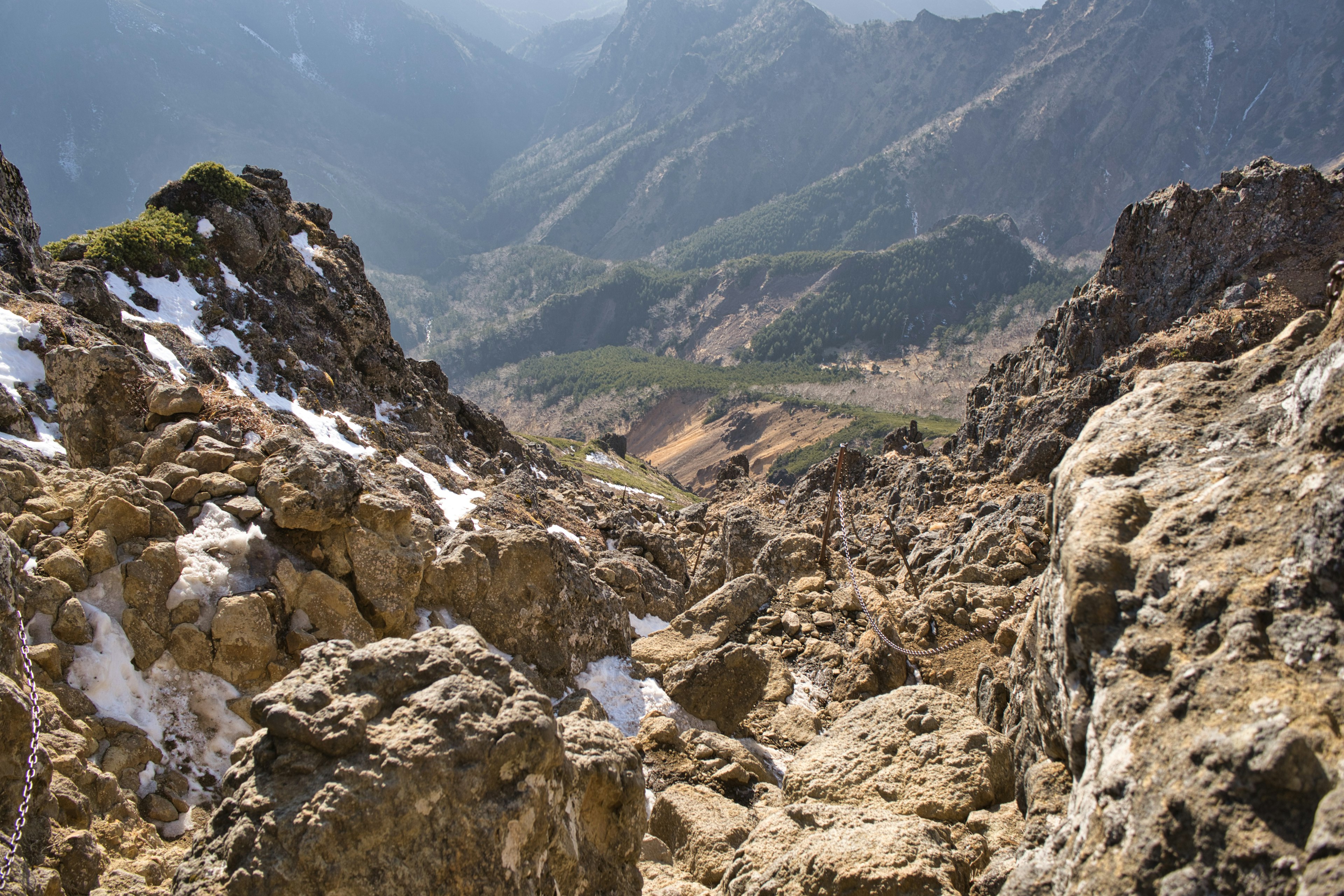 Steep mountain landscape with rocky terrain and valley view