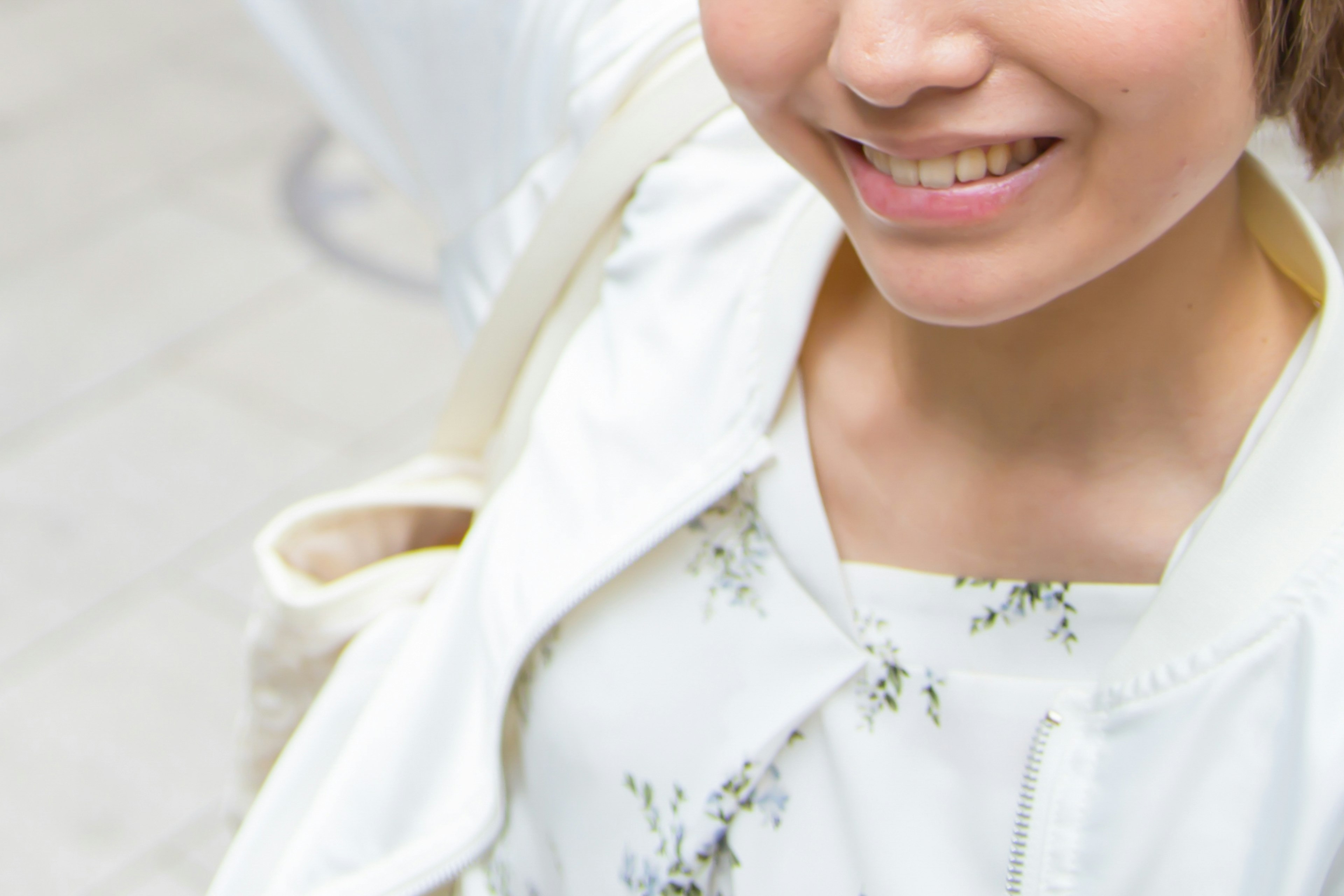 Femme souriante portant une veste blanche