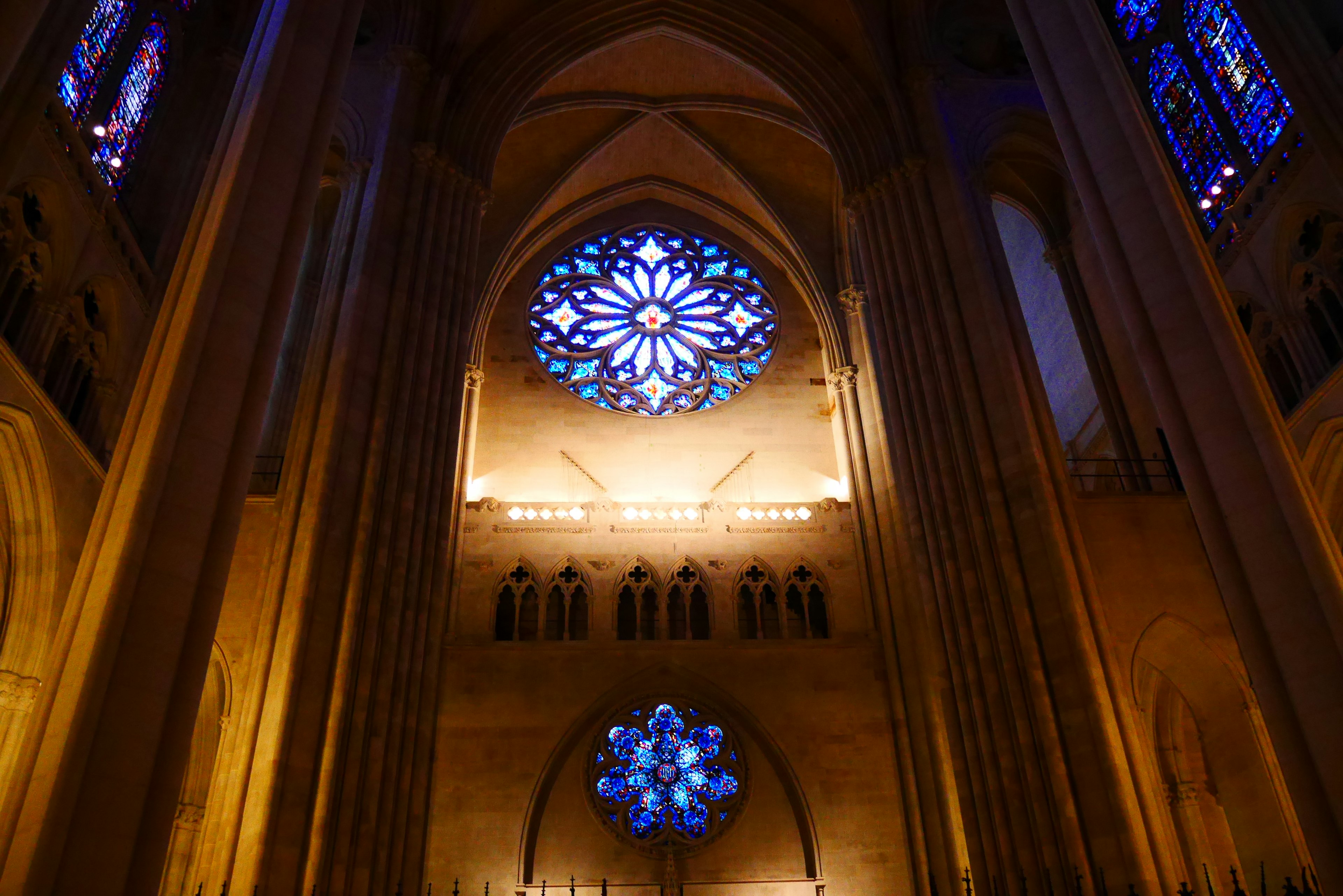 Interior of a cathedral featuring beautiful stained glass windows and high arched ceilings