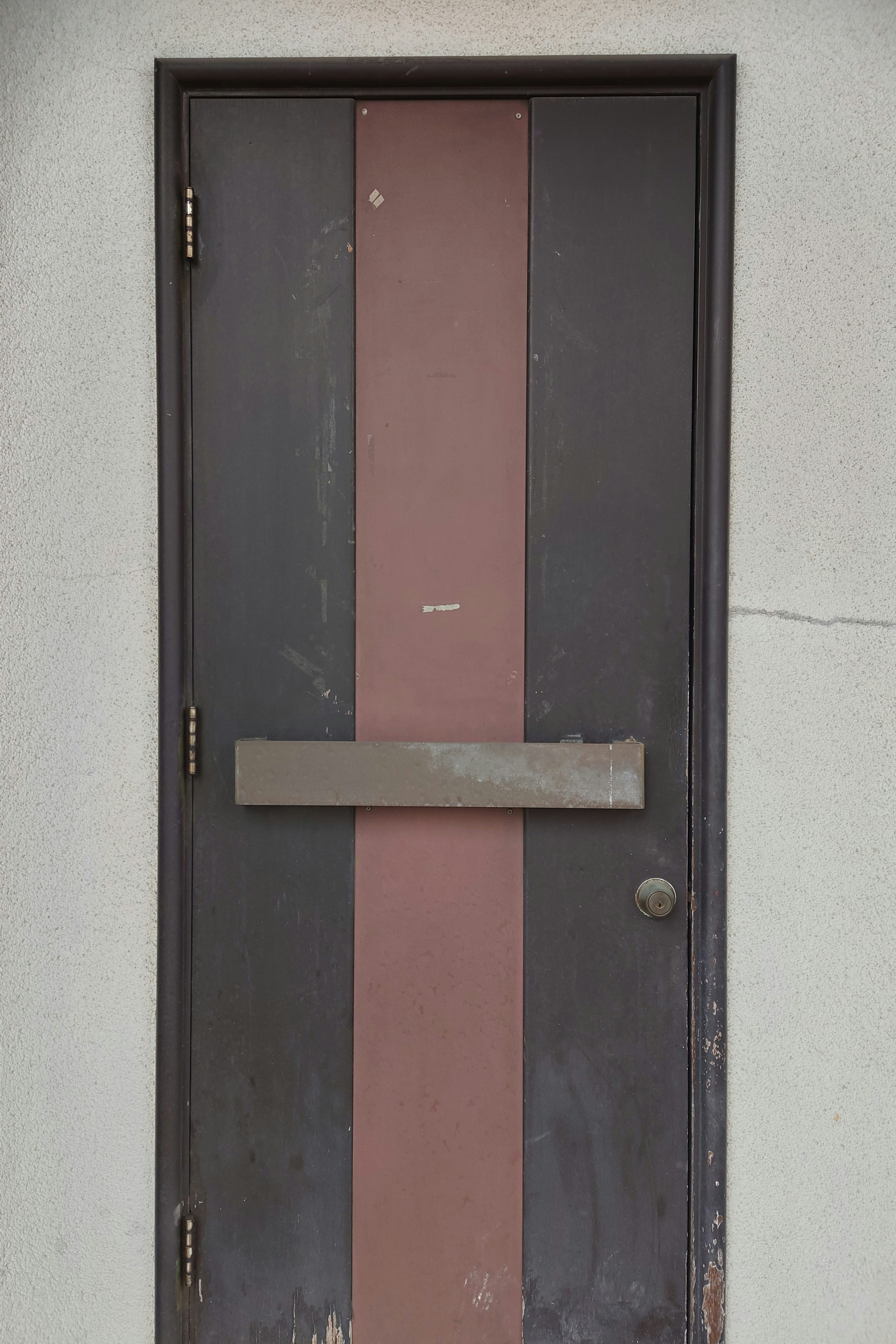 Black door with brown vertical stripes