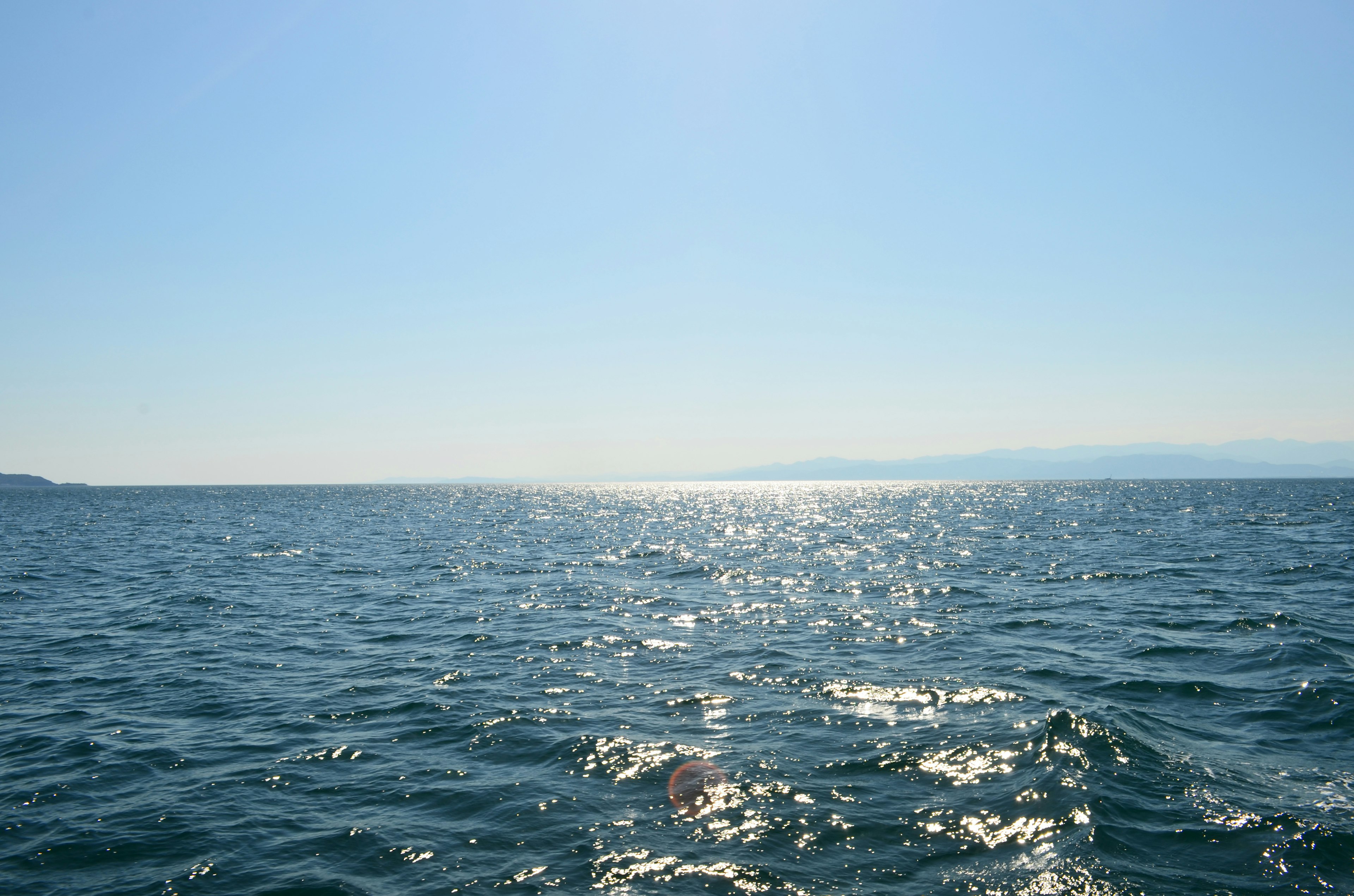 Vast blue ocean under a clear sky