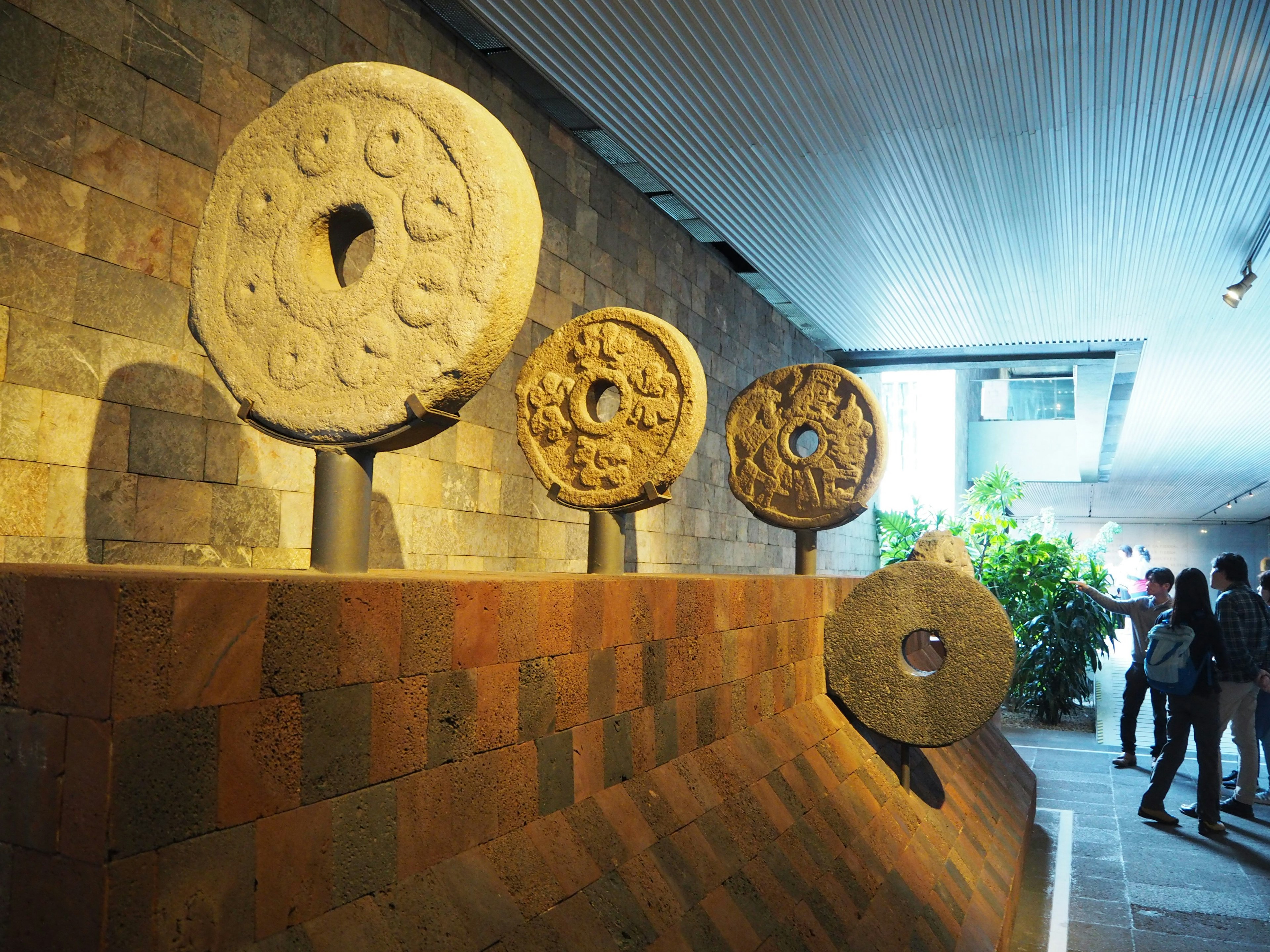 Ancient stone circular artifacts displayed in a museum interior