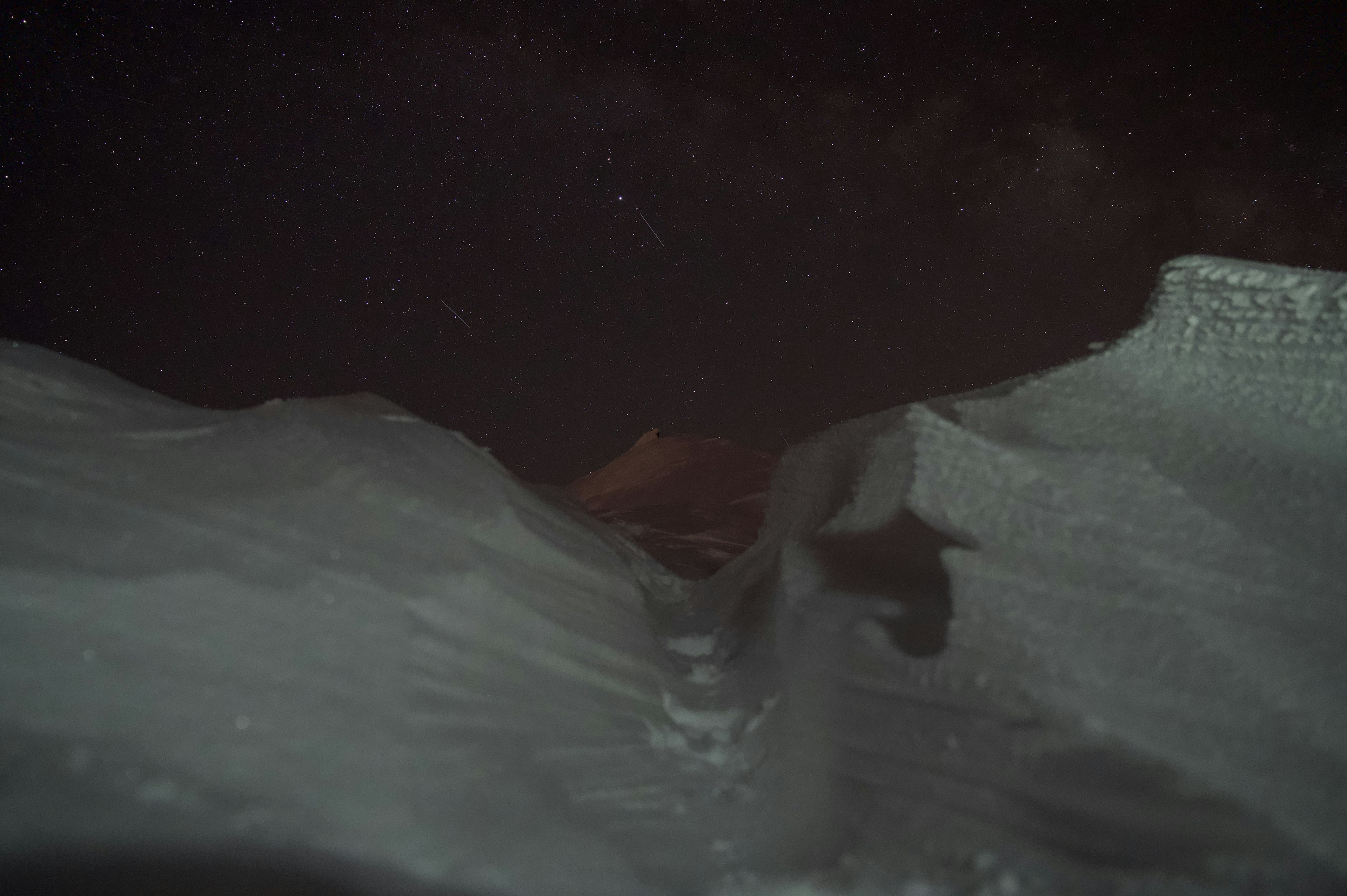 Snow-covered landscape with a starry night sky