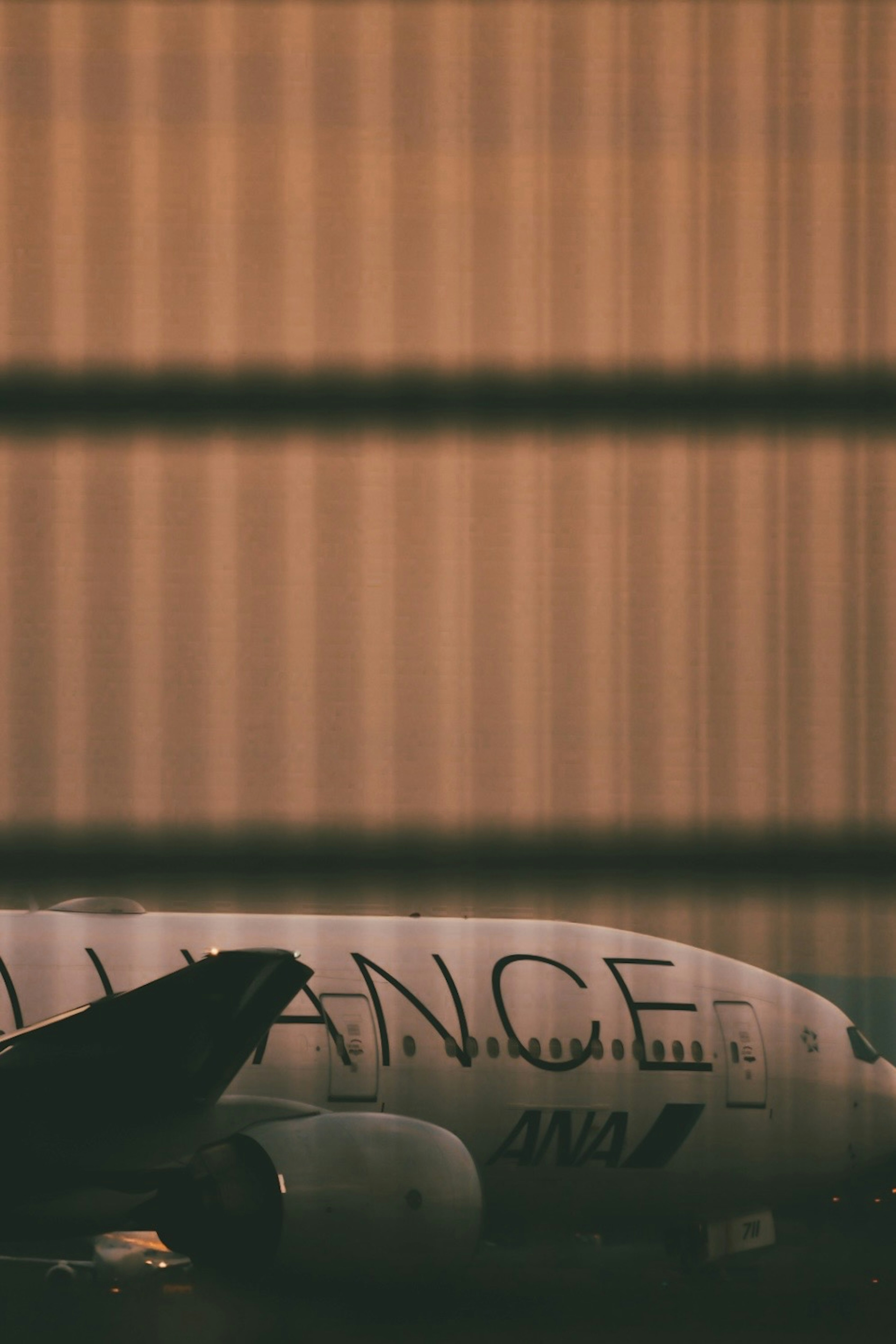 Side view of an airplane on the runway with visible lettering