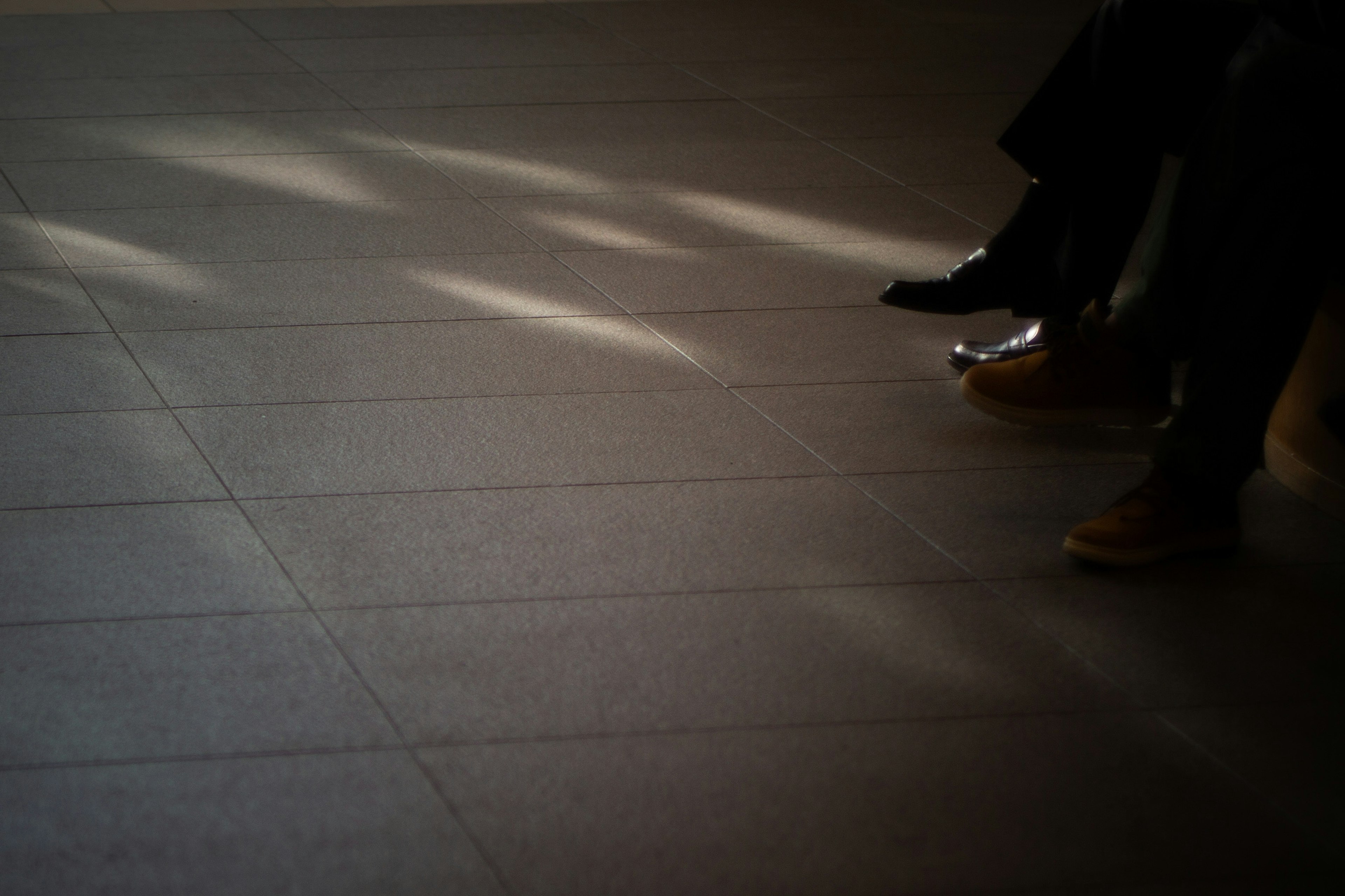 Image showing the feet and shoes of people sitting on a floor