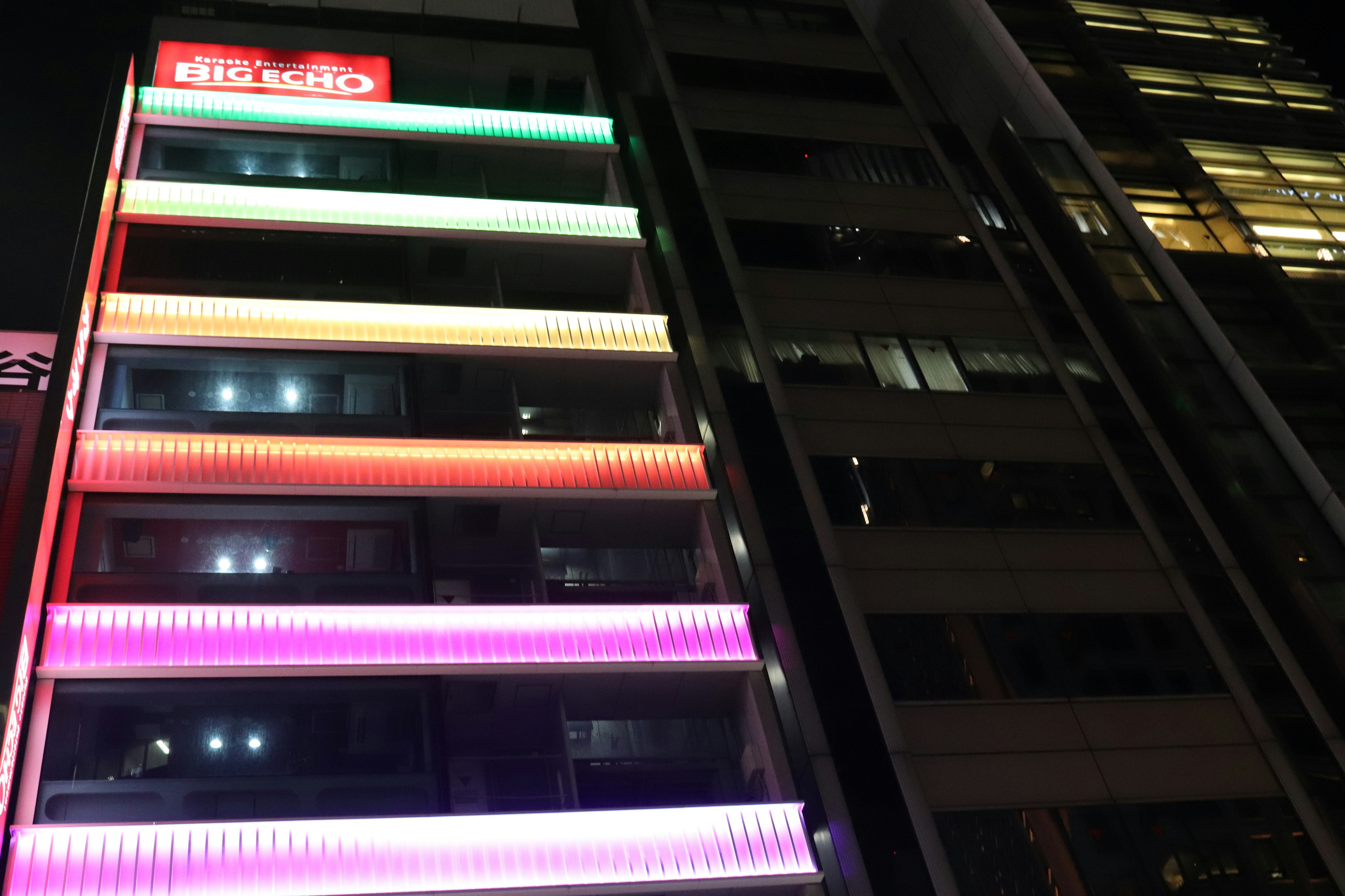 Bunte LED-Lichter beleuchten die Fassade eines Gebäudes bei Nacht