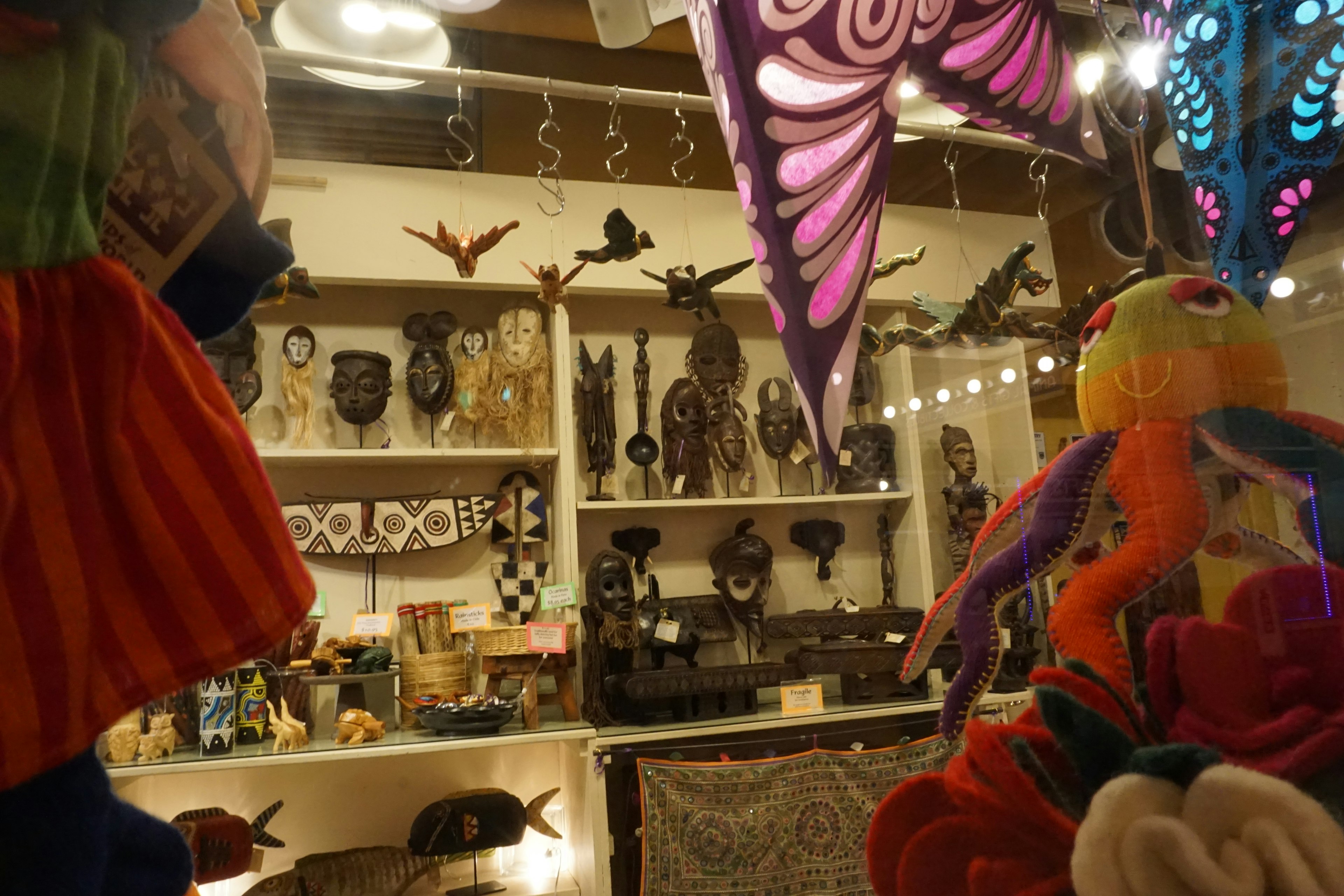 Image capturing a colorful display of masks and decorations in a shop