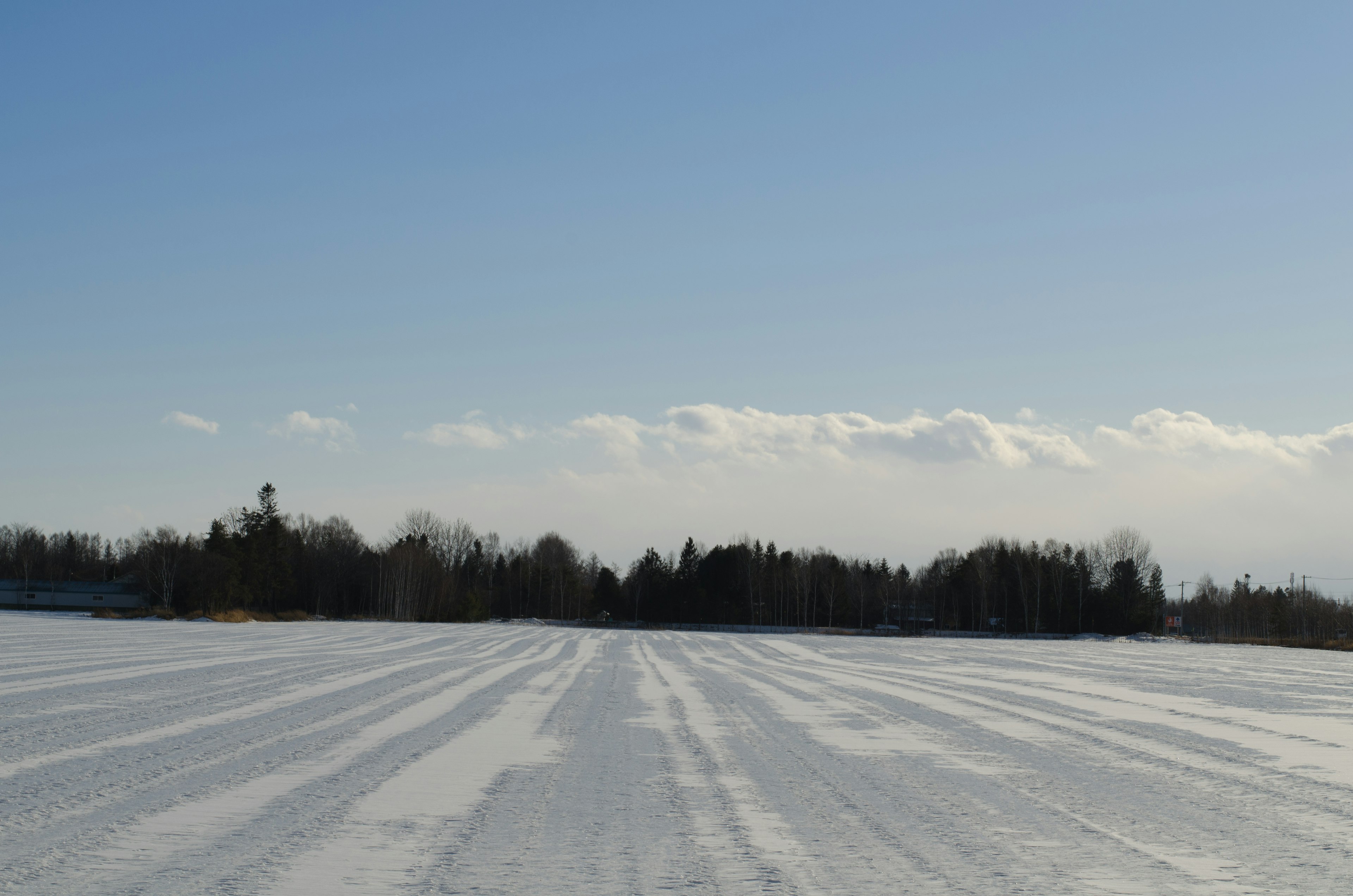 Snow-covered landscape with clear blue sky