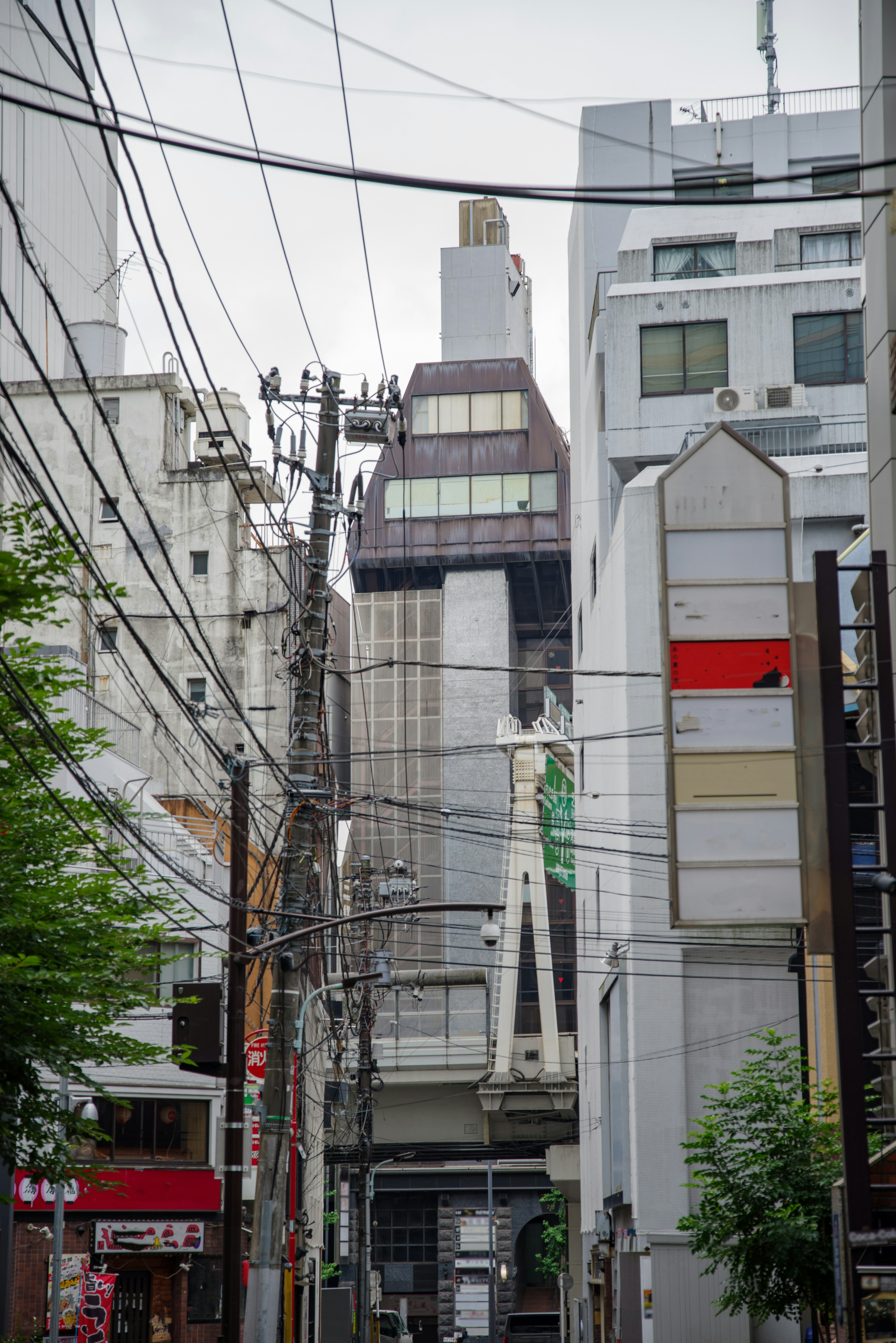 Urban street scene with intersecting power lines and buildings